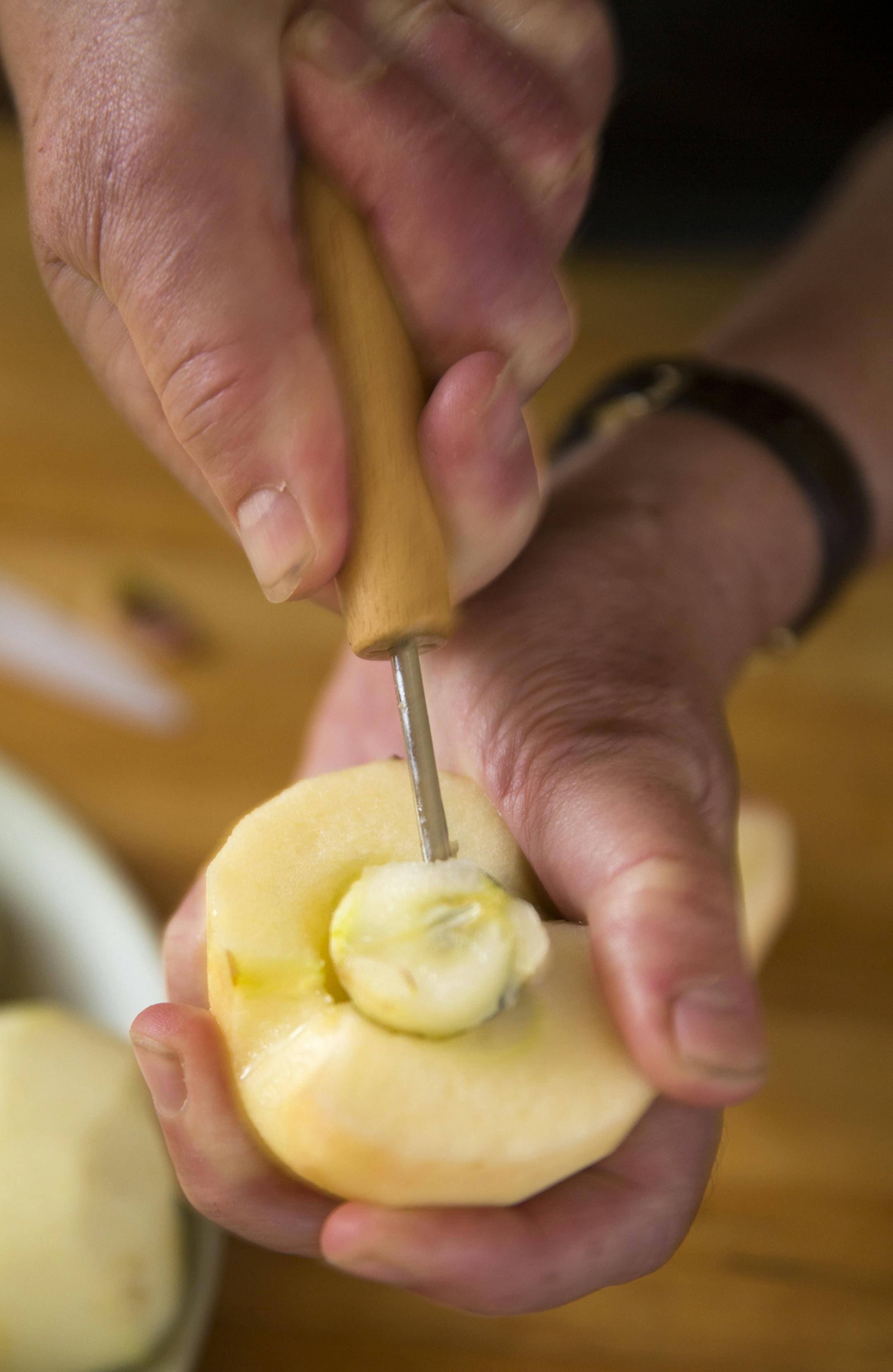 Core the halved apples. Baking Central makes Apple Tarte Tatin. ] (Leila Navidi/Star Tribune) leila.navidi@startribune.com BACKGROUND INFORMATION: Baking Central makes Tarte Tatin for apple season, with an easy, flaky pastry on Thursday, October 13, 2016.