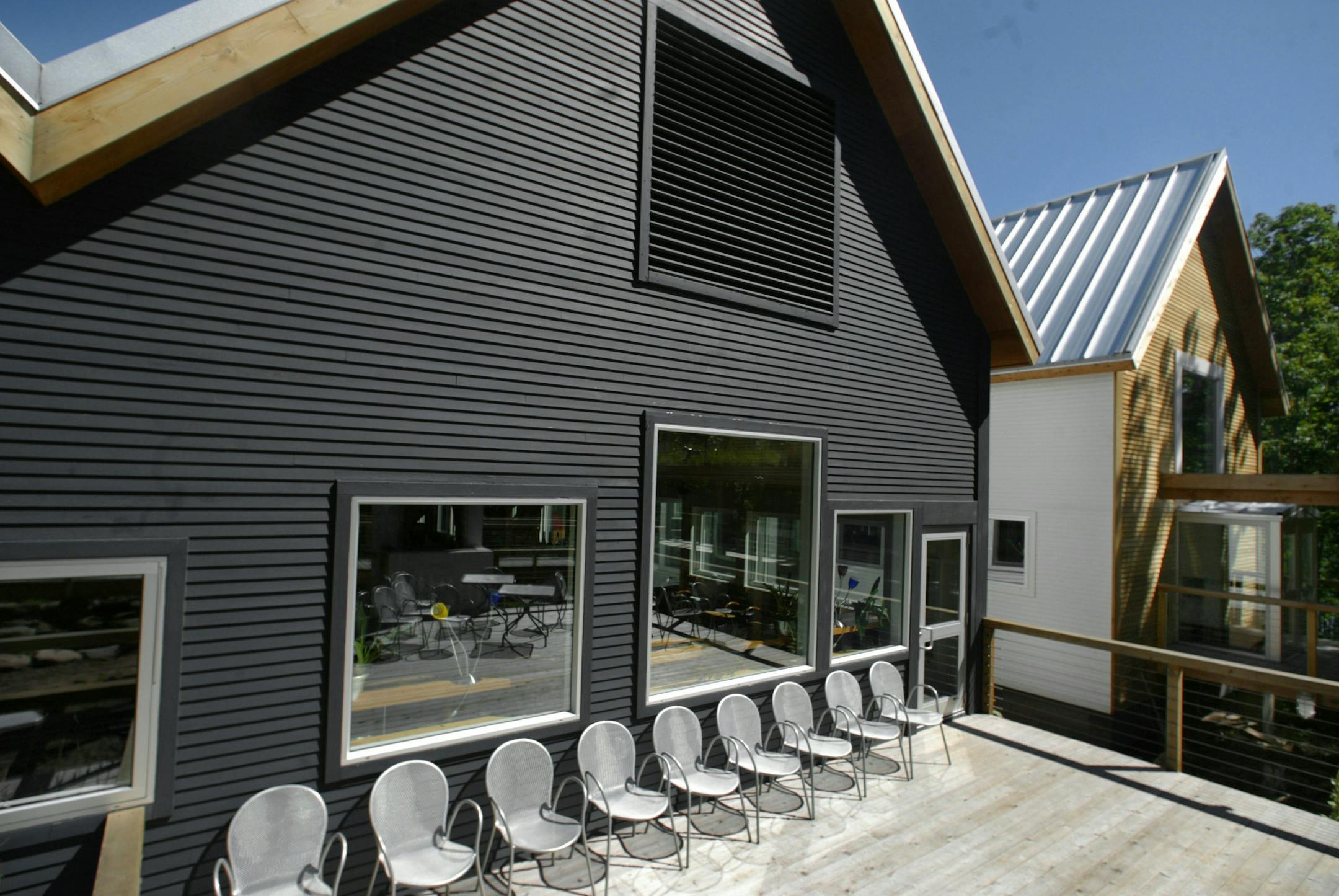 GENERAL INFORMATION: MARY RICE... The queen of Bayfield, and Wild Rice reste
IN THIS PHOTO: Bayfield Wisconsin 8/3/2002-- Wild Rice restaurant...from a front deck the dark building with peaked roofs houses the bar and private dining room with the kitchen stretching behind. to the far right of this photo is the entrance to the main dining room, accessed by a separate cedar decking walkway that is covered.