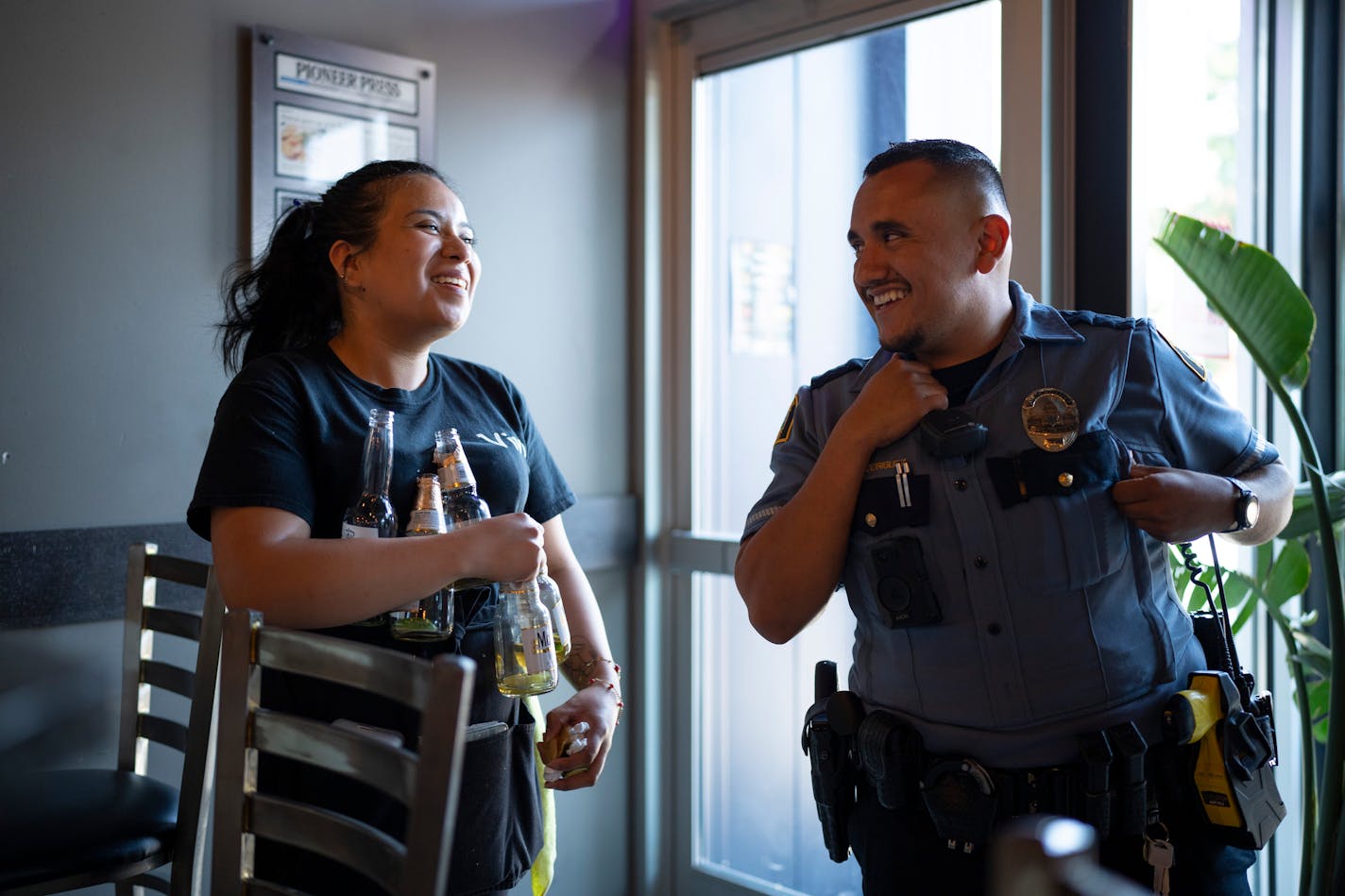 St. Paul police officer Victor Rodriguez joked with server Vivi Ruiz during a stop at La Costa on Cesar Chavez St. on St. Paul's West Side.