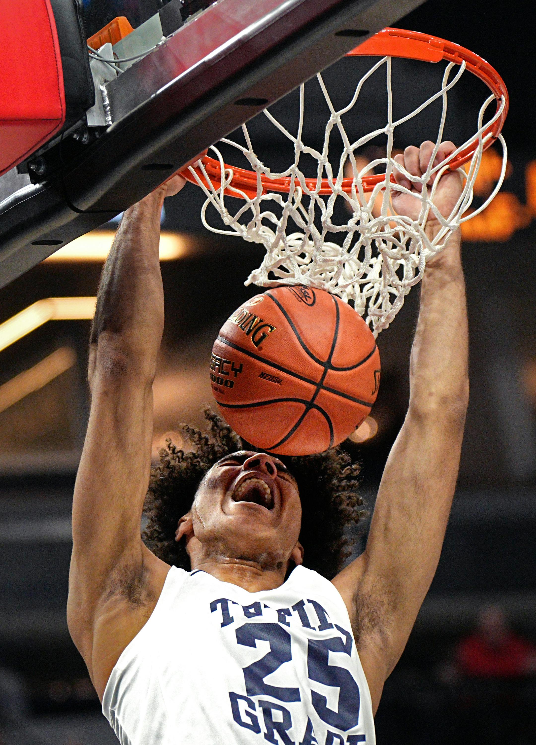 Totino-Grace's Pierless Davis dunks in the first half against Alexandria.
