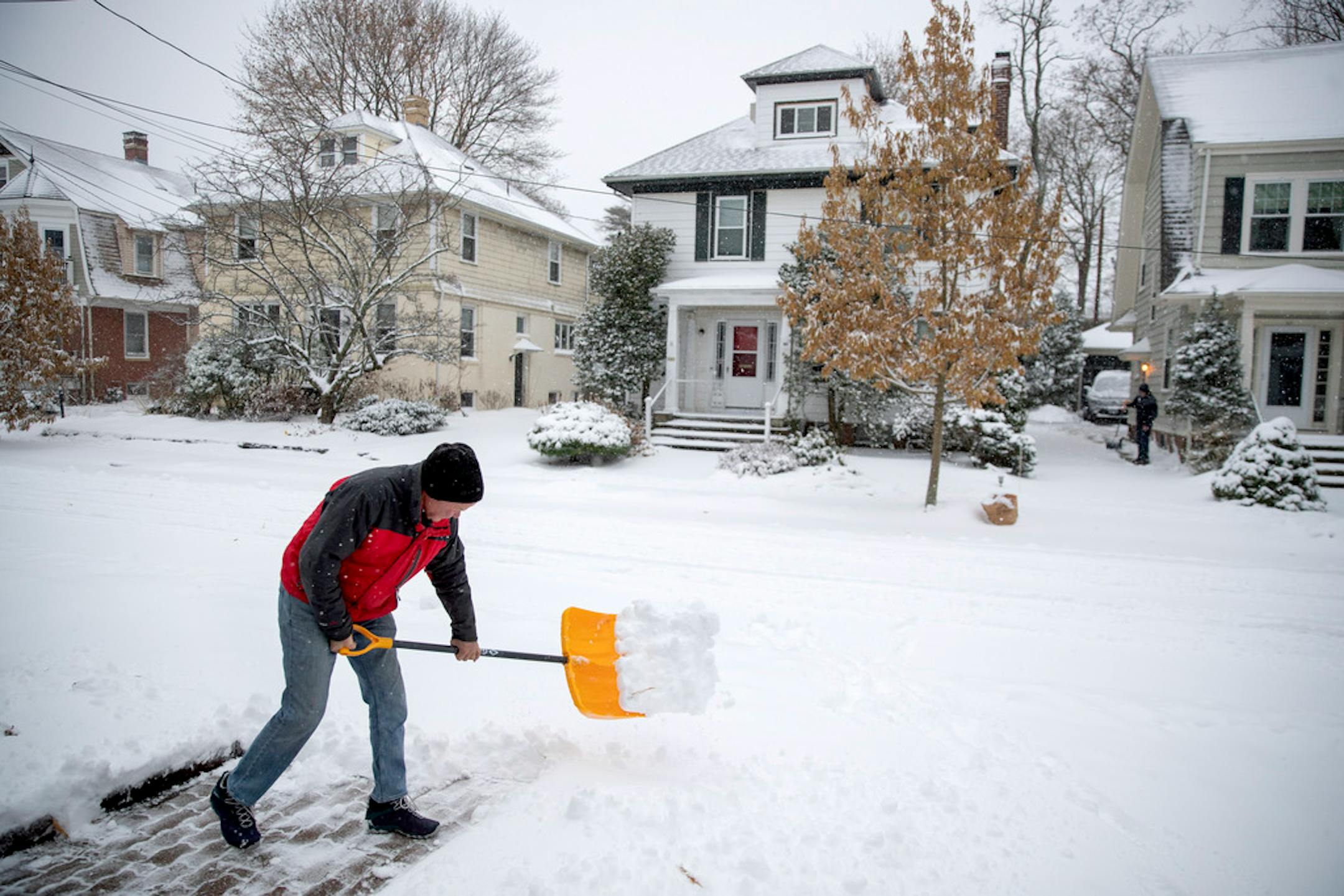 .Man shown shoveling snow outside his Providence, R.I., home.