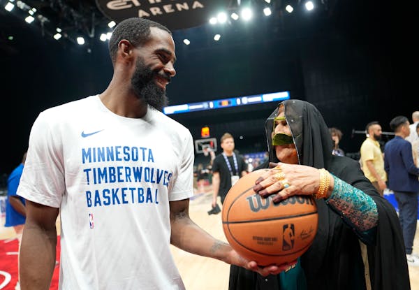 Timberwolves guard Mike Conley visited with an Emirati woman during a practice session in Abu Dhabi this week.