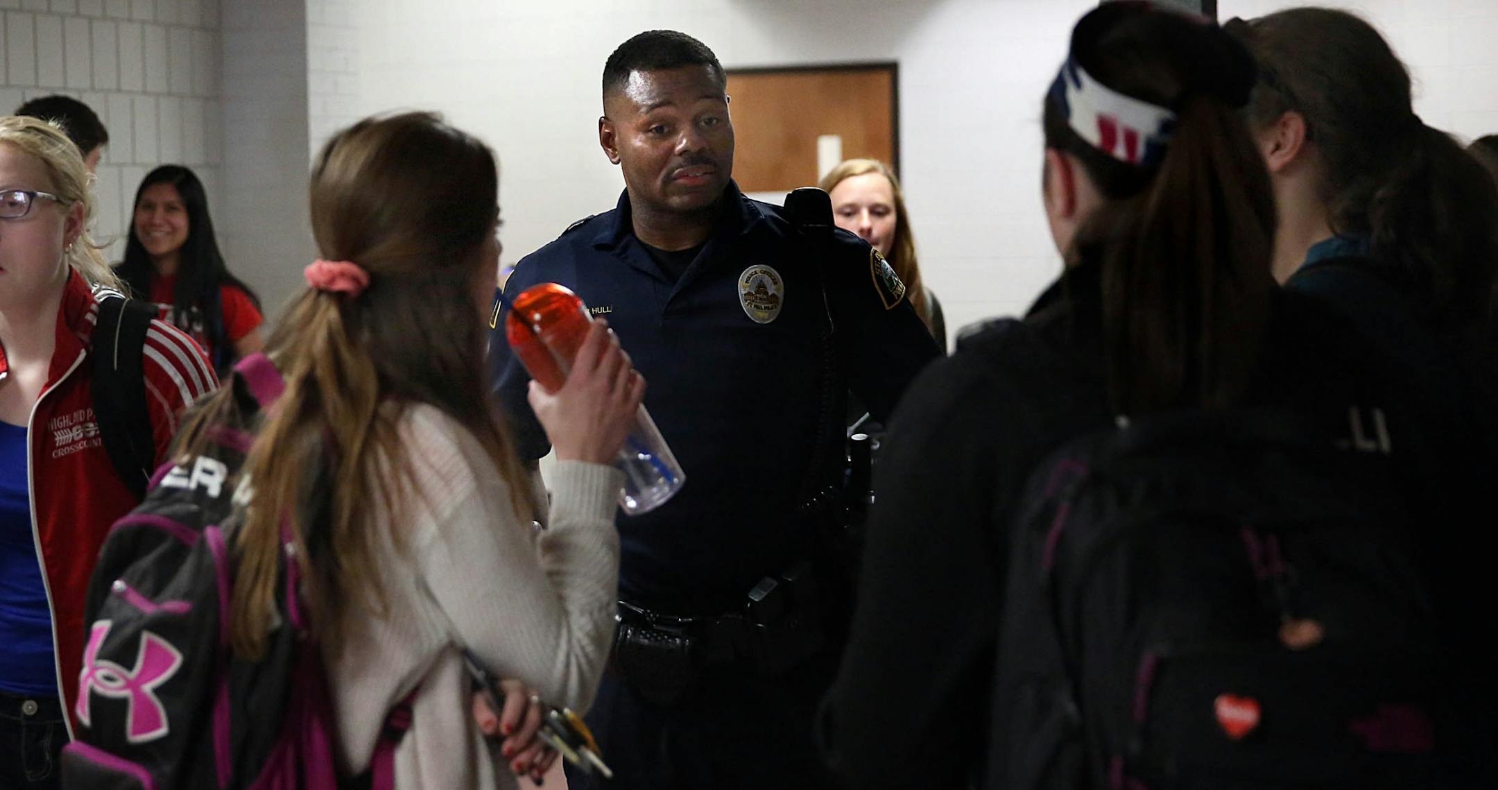 Cortez Hull, school resource officer (SRO) at Highland Park High School in St. Paul, interacted with students at the end of the school the day.