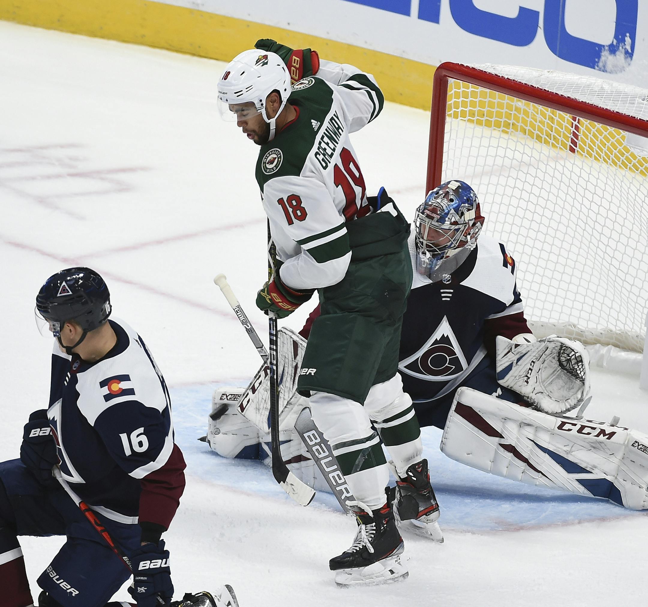Colorado Avalanche goaltender Philipp Grubauer (31) makes a save on a shot as Minnesota Wild left wing Jordan Greenway (18) screens him during the third period in an NHL hockey game Saturday, Oct. 5, 2019 in Denver. The Colorado Avalanche defeated the Minnesota Wild 4-2. (AP Photo/John Leyba)