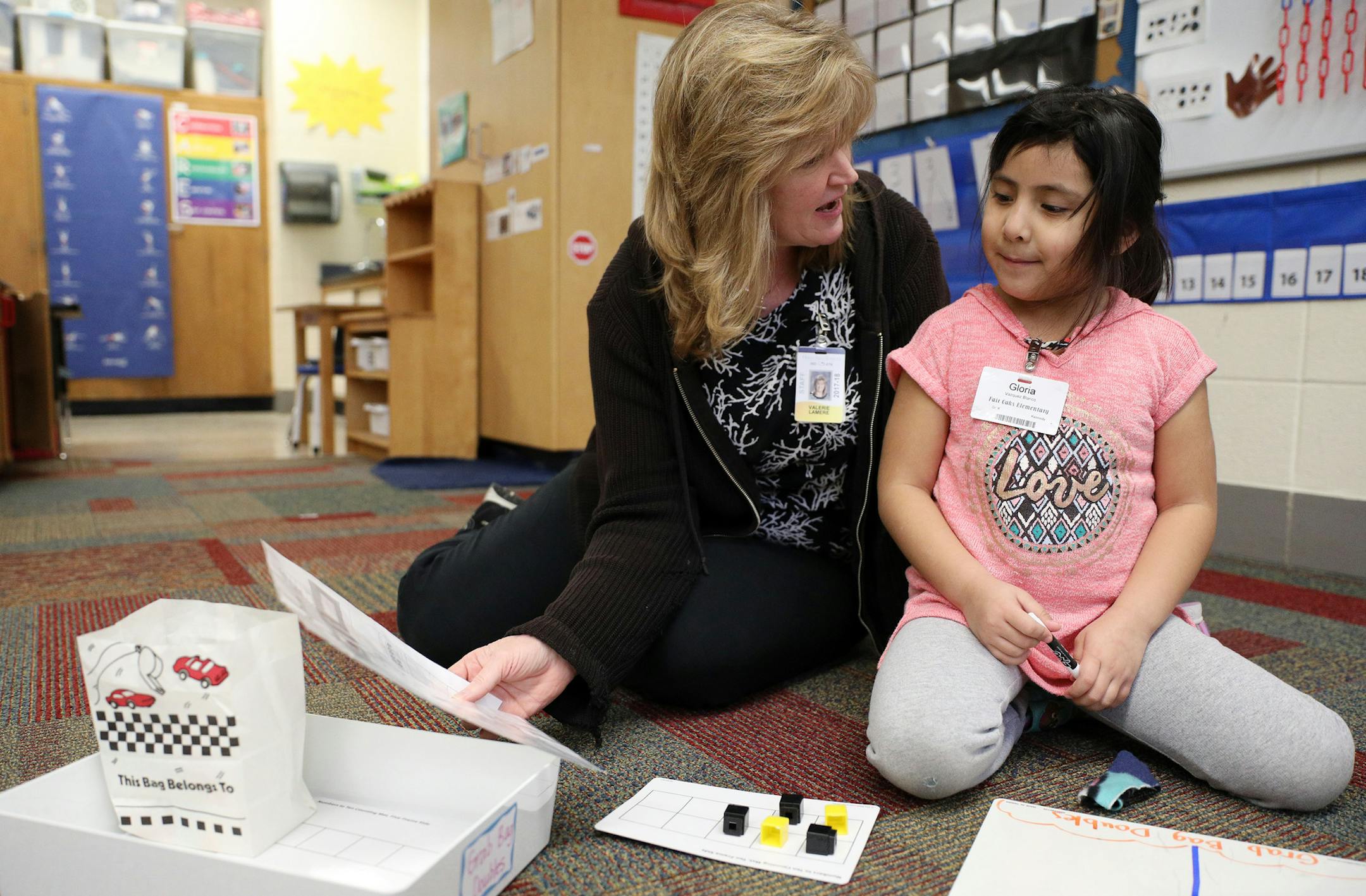 Valerie Lamere worked with Gloria Vazquez Blanco on a math probelm. ] ANTHONY SOUFFLE &#xef; anthony.souffle@startribune.com Michelle Kennedy taught a group of students during math class Wednesday, Jan. 10, 2018 at Fair Oaks Elementary School's in Brooklyn Park, Minn. School districts in the suburbs have revamped their math curriculums, moving away from memorizing formulas to focusing more on engagement and confidence building.