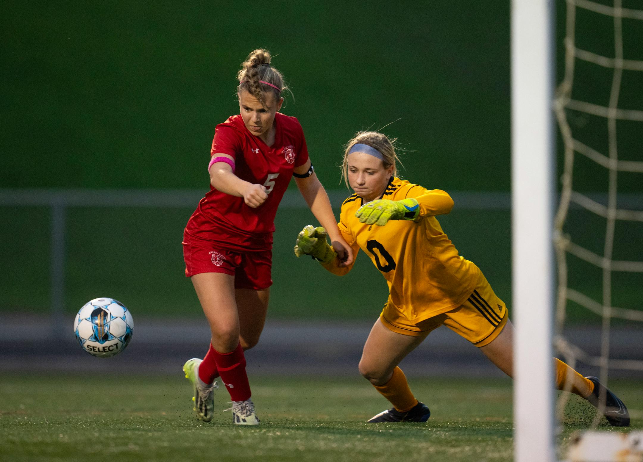 Benilde-St. Margaret's Hannah Buller and Mankato East keeper Ashley Fischer battled for control of the ball in front of the net in the first half.