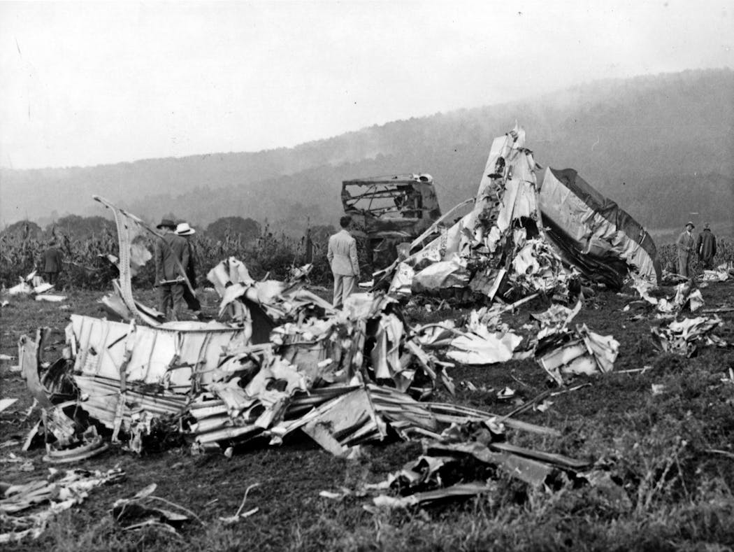 People examine the wreckage of the crash in Lovettsville, Virginia that killed Sen. Ernest Lundeen and 24 others.