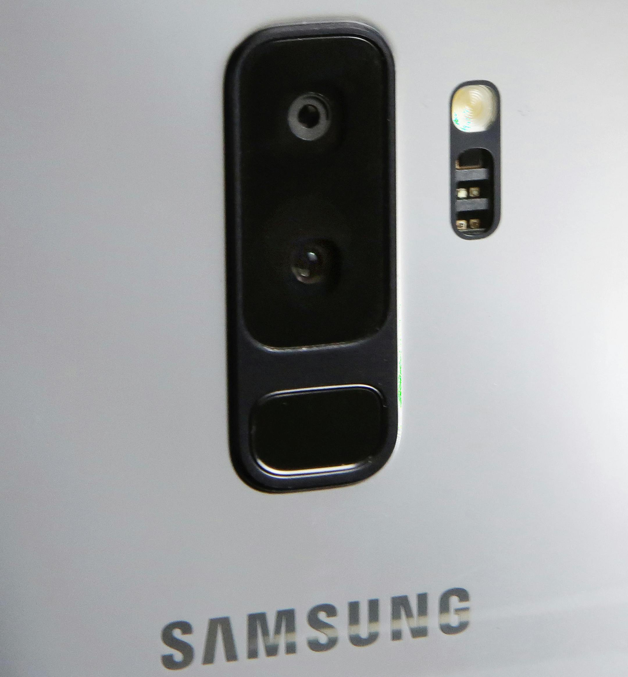 FILE- In this Feb. 21, 2018, file photo, the dual camera lens of the Samsung Galaxy S9 Plus mobile phone is shown in this photo during a product preview in New York. The Galaxy S9 phones will be available March 16. (AP Photo/Richard Drew)