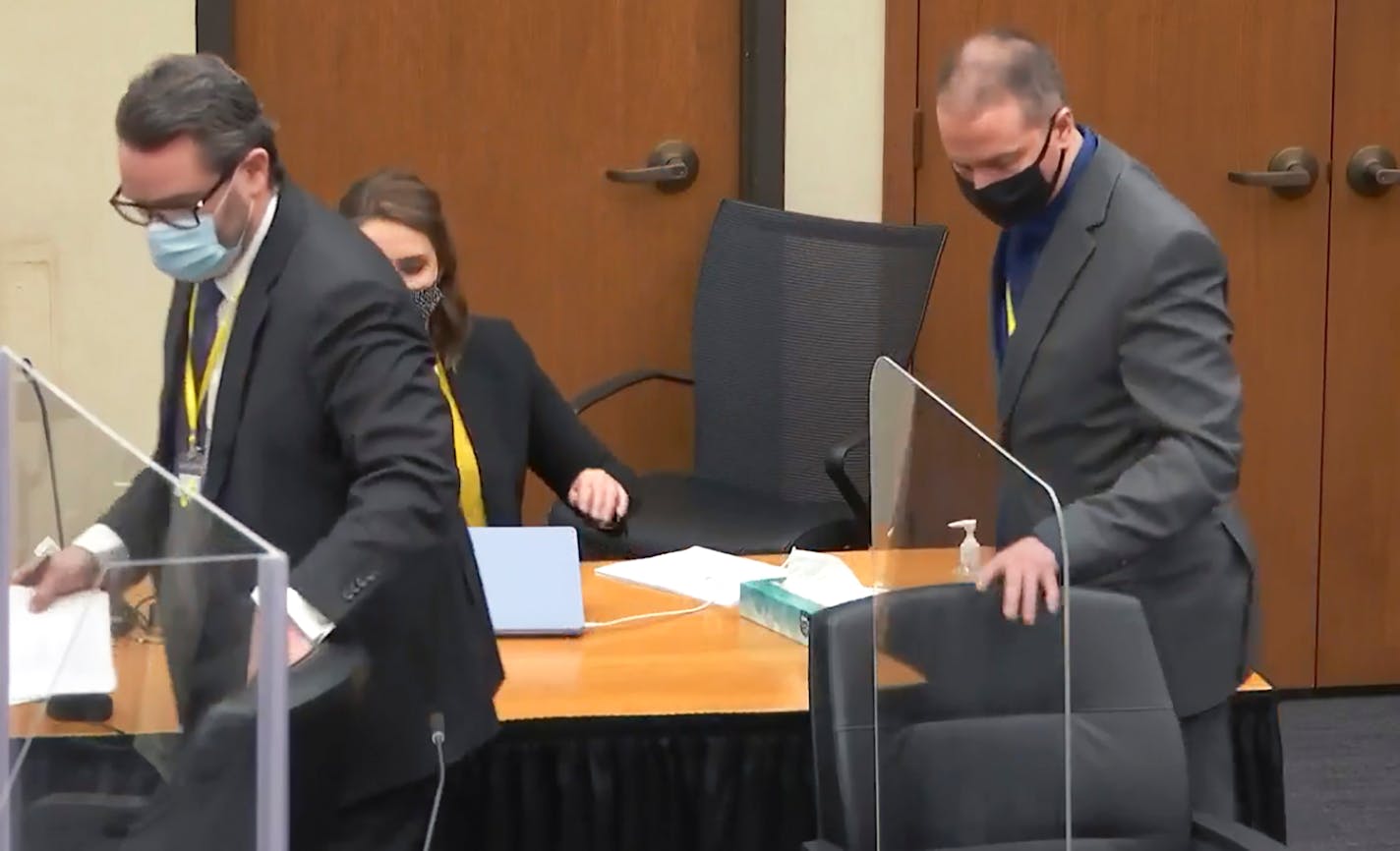 In this image taken from video, defense attorney Eric Nelson, left, and defendant former Minneapolis police officer Derek Chauvin take their seats after a discussion as Hennepin County Judge Peter&nbsp;Cahill presides over jury selection, Wednesday, March 10, 2021, at the Hennepin County Courthouse in Minneapolis, Minn., in the trial of Chauvin, accused in the May 25, 2020, death of George Floyd. (Court TV/Pool via AP)