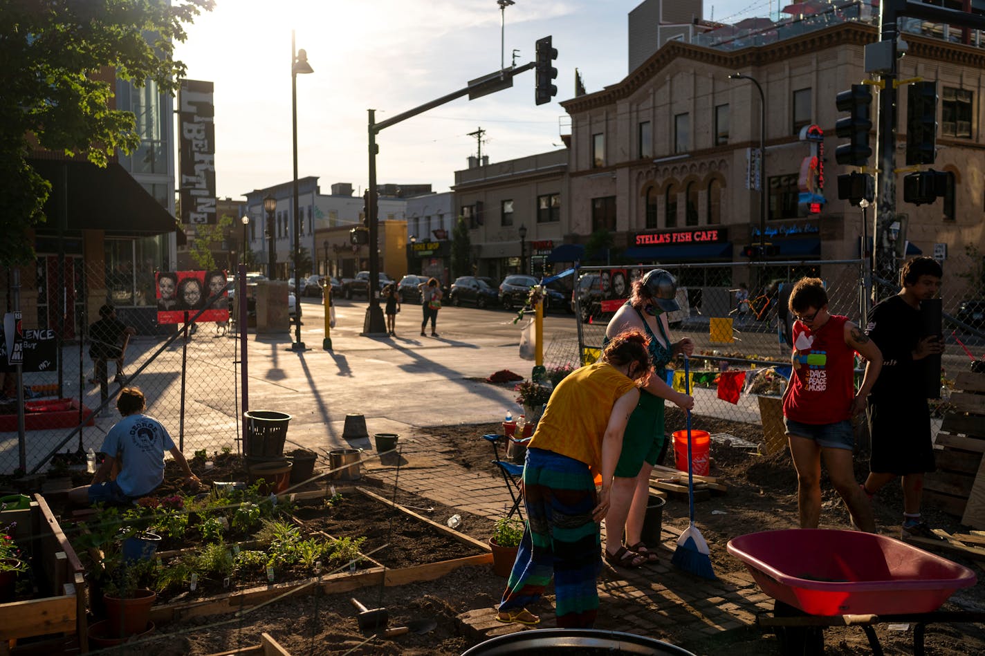 Activists work on improving the Wince Marie Peace Garden in Uptown on June, 23, 2021, in Minneapolis. The garden was constructed a few days after the death of Deona Marie and serves, in part, as a memorial for both Marie and Winston Smith. ] ANTRANIK TAVITIAN • anto.tavitian@startribune.com