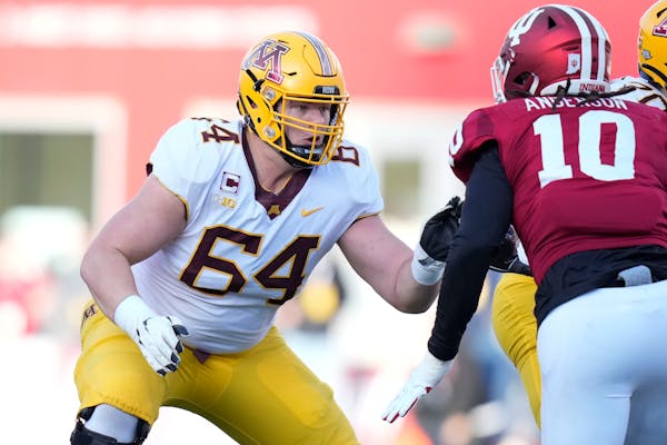 Minnesota offensive lineman Conner Olson (64) defends against Indiana defensive lineman Ryder Anderson (10) in the first half during an NCAA college f