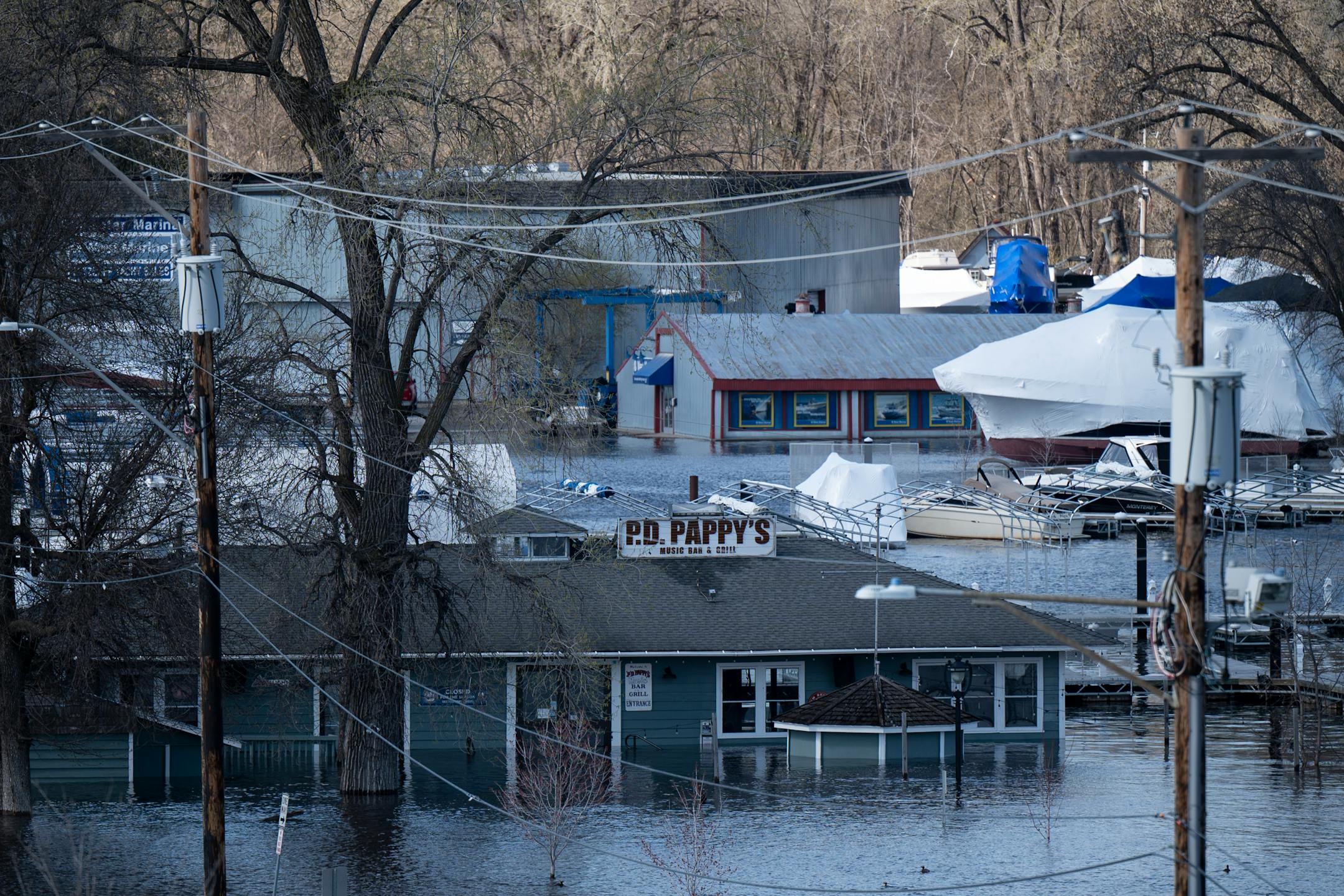 P.D. Pappy's Music Bar and Grill, Stillwater Marine Services and West Marine are all flooded out by the rising St. Croix River on Monday, April 17, 2023 in Stillwater, Minn.