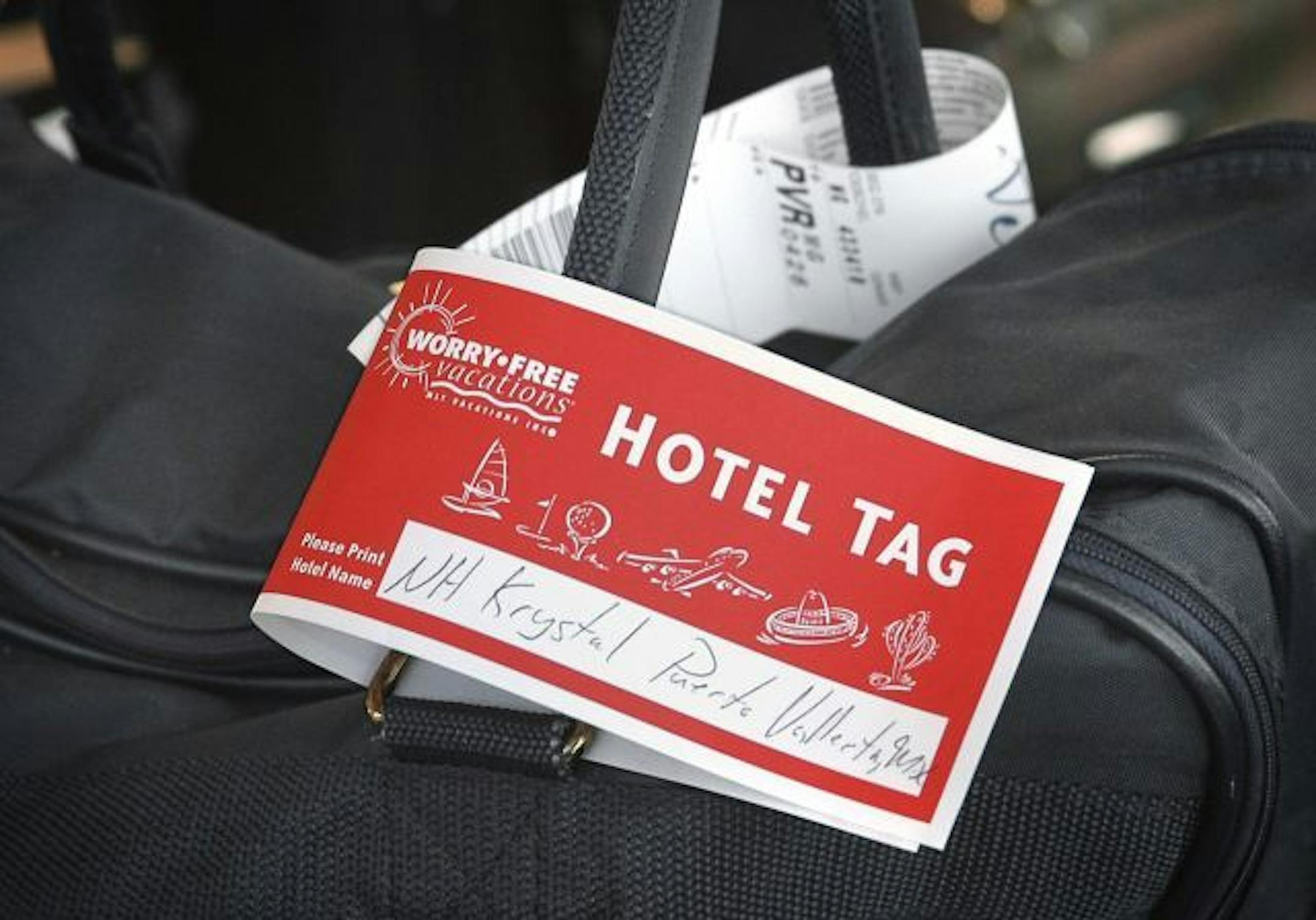 A MLT Worry-Free Vacations hotel tag for the NH Krystal Hotel in Puerta Vallarta, Mexico.