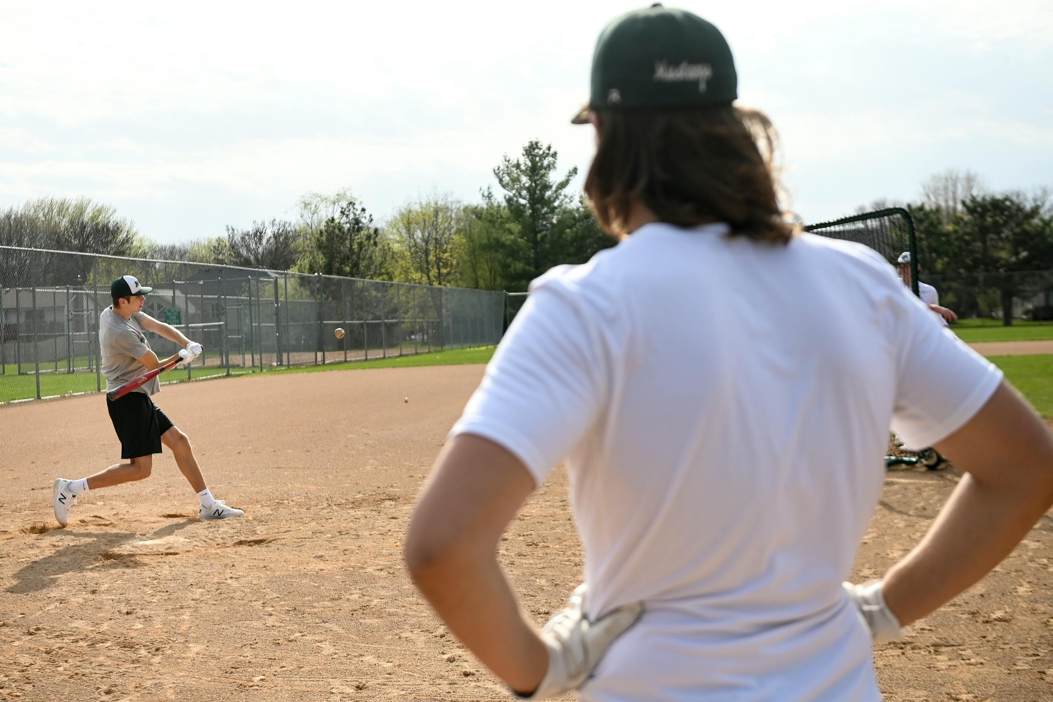 Mounds View senior Ike Mezzenga watched teammates Jack Hentges hit balls during an informal batting practice Friday afternoon.