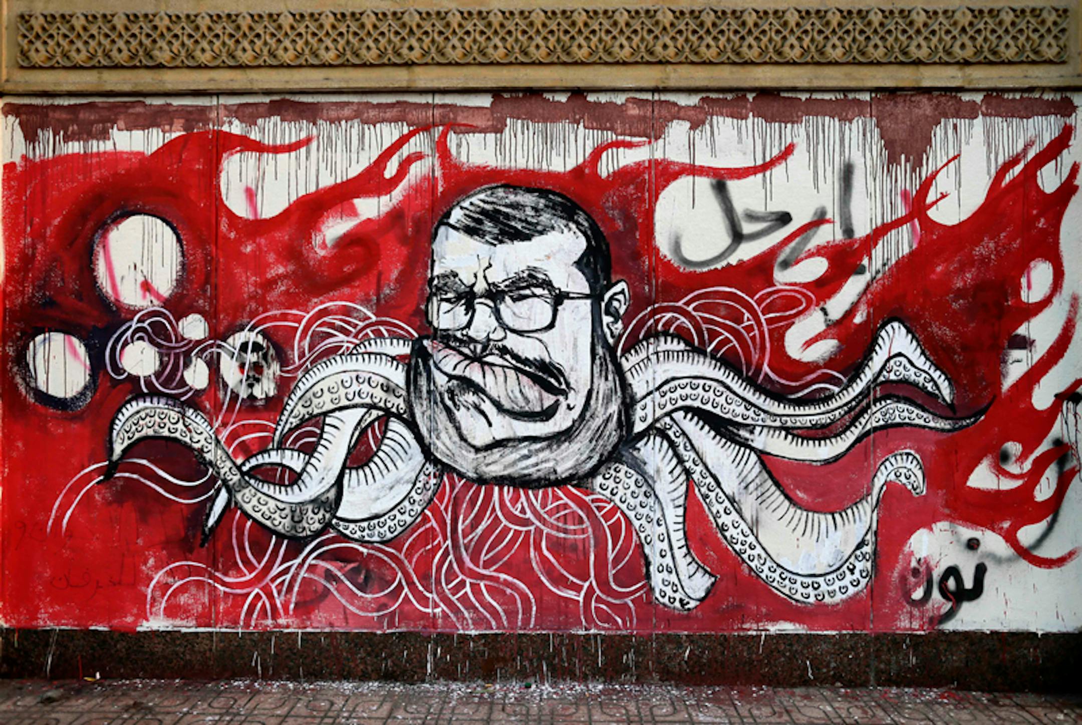 In this Saturday, Dec. 8, 2012 file photo, Graffiti depicting Egyptian President Mohamed Morsi covers an outer wall of the presidential palace in Cairo, Egypt. Some six months since becoming the first democratically elected president of Egypt, Morsi is widely accused of having abandoned pledges of inclusive government for doctrinaire and authoritarian ways. (AP Photo/Hassan Ammar, File)