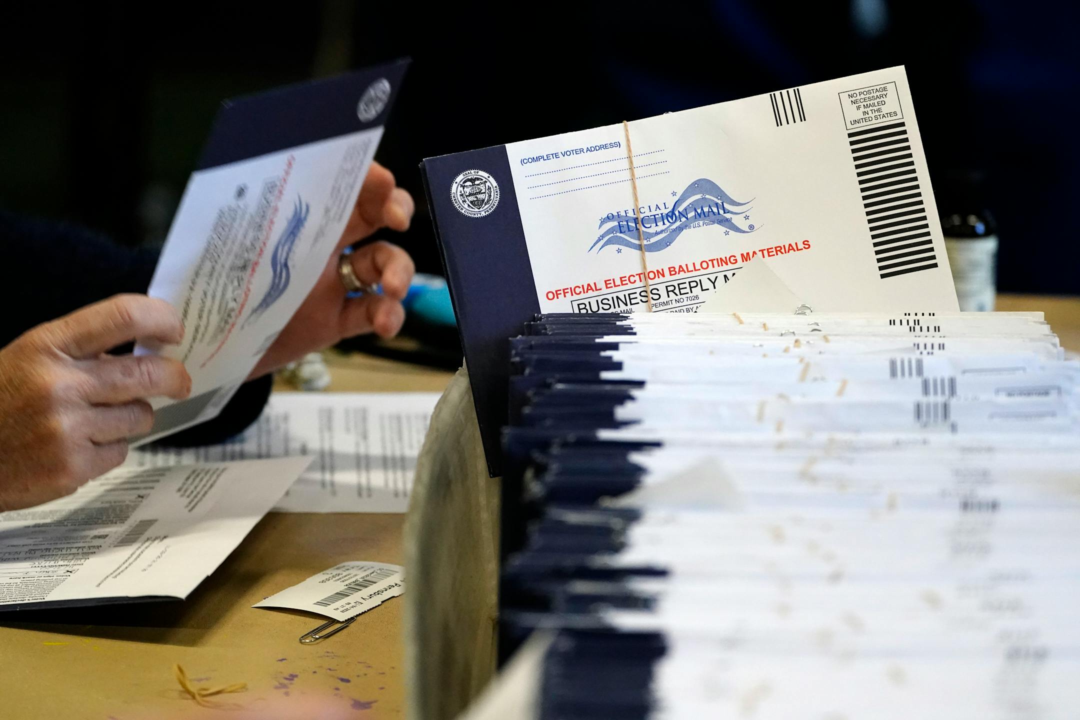 Chester County, Pa. election workers process mail-in and absentee ballots at West Chester University, Wednesday, Nov. 4, 2020, in West Chester.