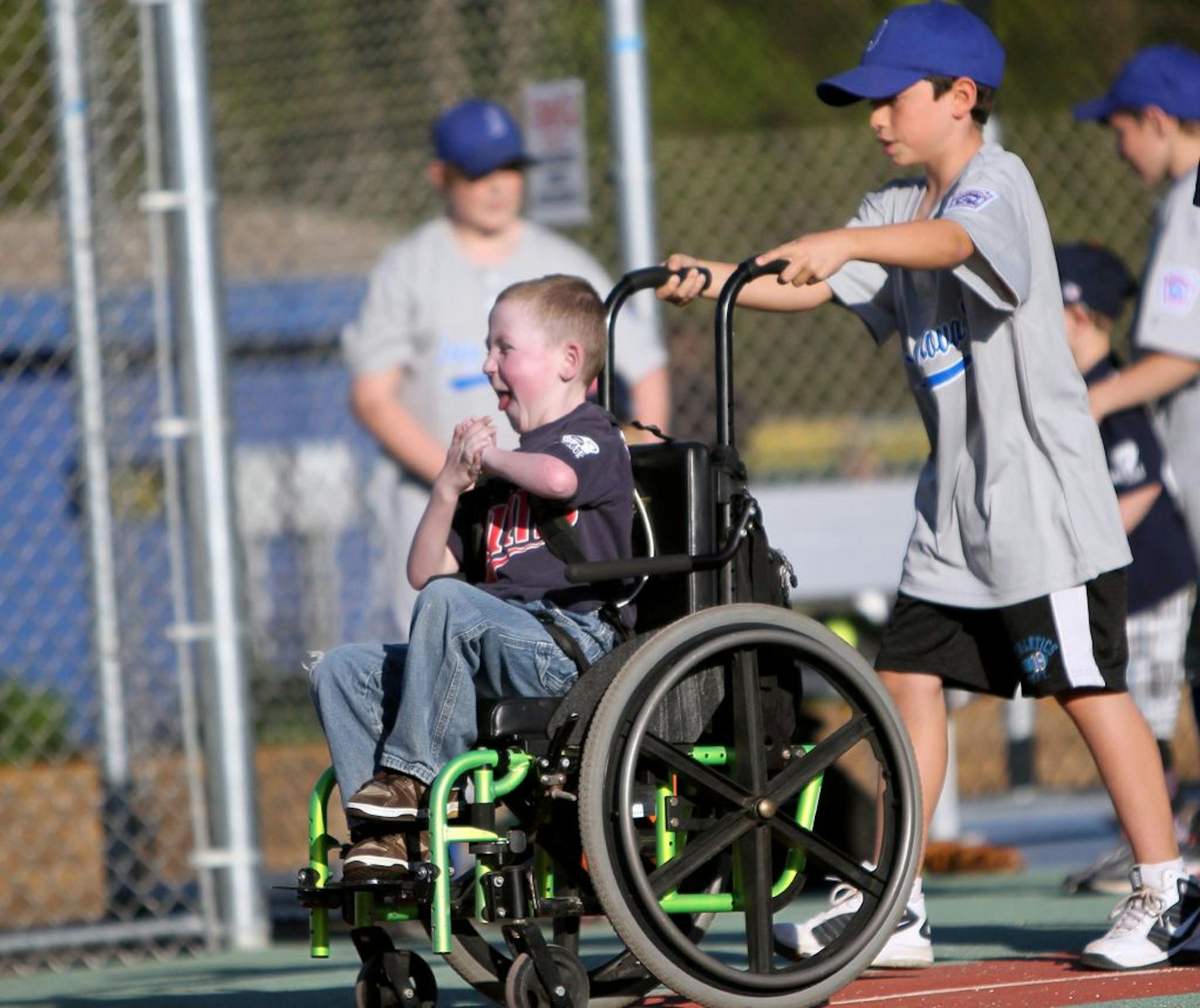 Andrew Combs squealed with excitement as he approached home plate with help from his buddy Andy Sumner during a West Metro Miracle League game.