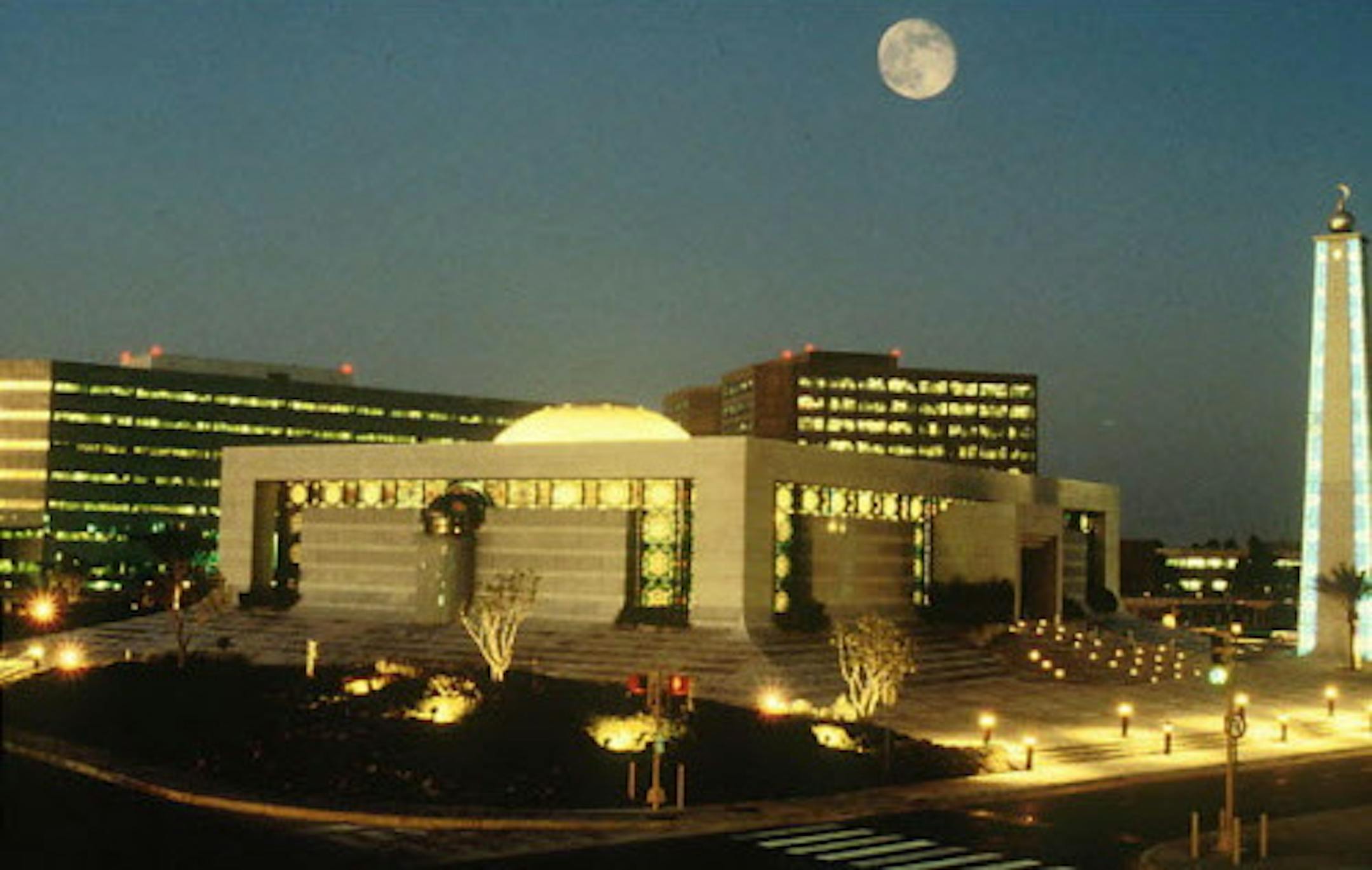 Saudi Armaco Saudi Aramco's core area which includes the headquarters and office buildings in Dhahran city. The buildings which appear in this picture are the Engineering Building, Admin Towers, Almujamma' Mosque, and the Old Administration Building. The buildings which appear in this picture are the Al Mujamma Mosque (foreground), Administration buildings (right background Two Towers), Old Admin Building (right background shown between Mosque and Minaret) and Engineering building (left backgrou