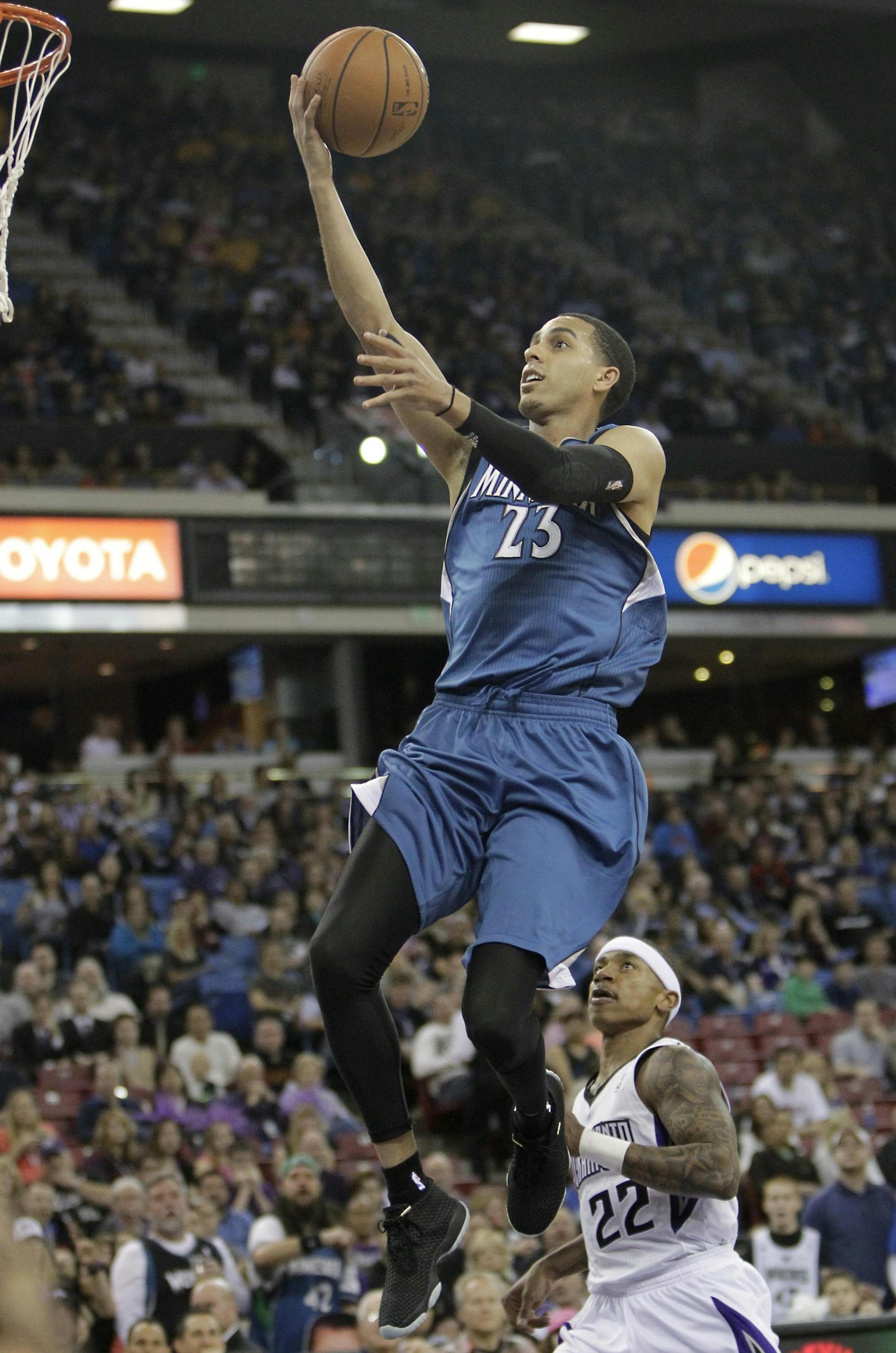 Minnesota Timberwolves guard Kevin Martin, left, drives to the basket past Sacramento Kings guard Isaiah Thomas during the first quarter of an NBA basketball game in Sacramento, Calif., Saturday, March 1, 2014.(AP Photo/Rich Pedroncelli)