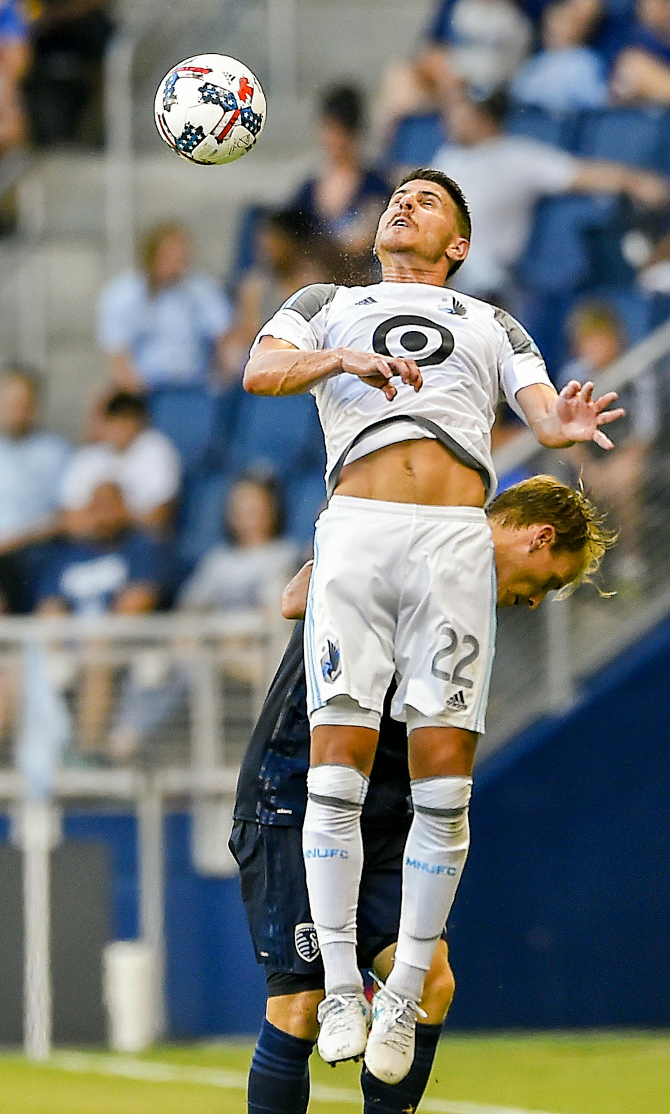 Minnesota United defender Kevin Venegas (22) did a header in front of Sporting Kansas City defender Seth Sinovic (15) during the first half of the MLS soccer match on Wednesday at Children's Mercy Park in Kansas City, Kan. Sporting Kansas City lead 2-0 at the half. ORG XMIT: B7310295257Z.1