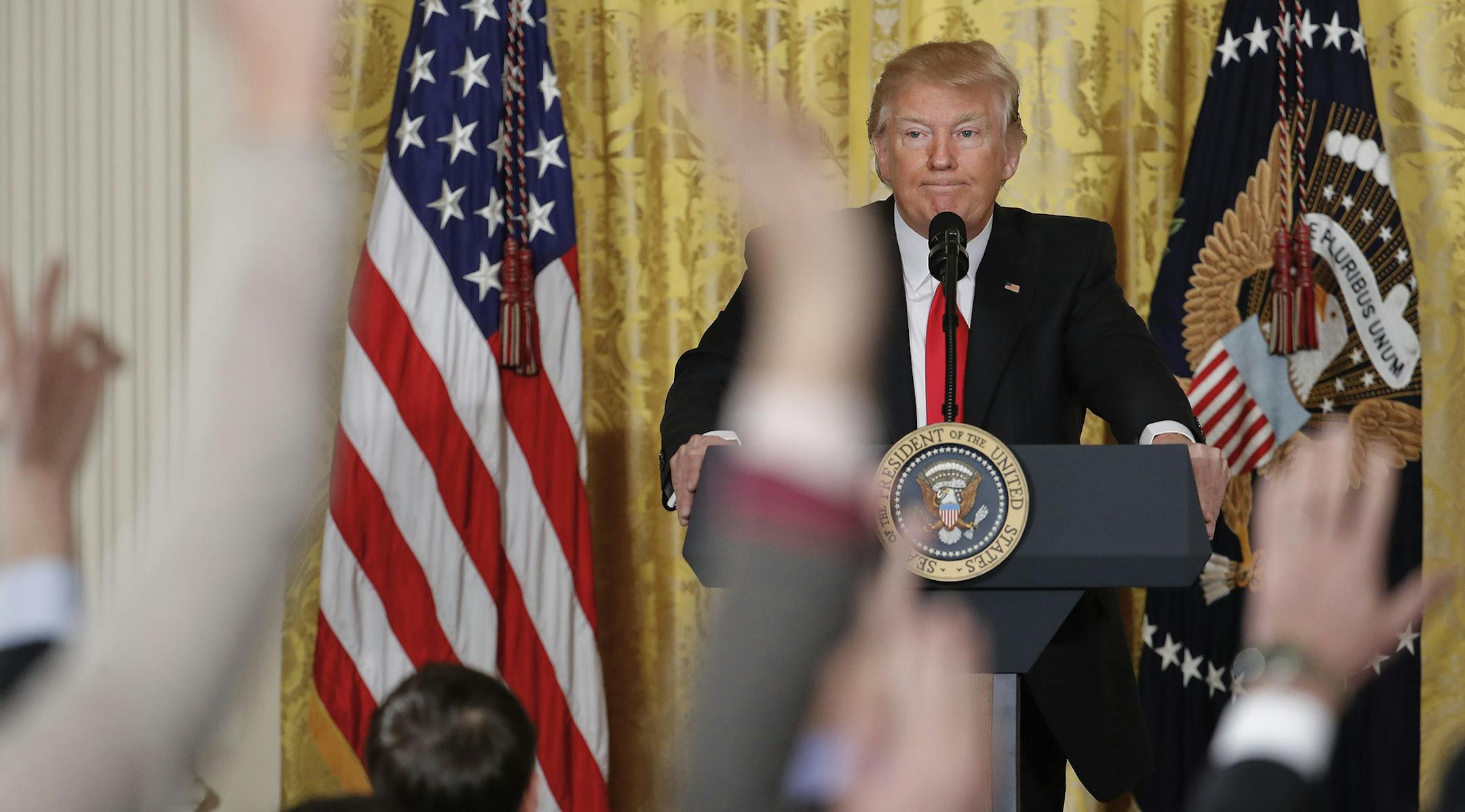 Reporters raise their hands as President Donald Trump fields questions during a news conference in the East Room of the White House in Washington, Thursday, Feb. 16, 2017.