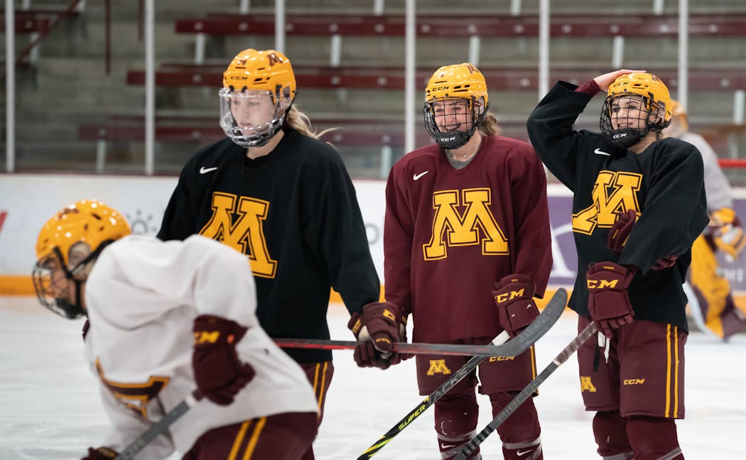 Heise, center in red jersey, has 64 points in 36 games this season and her 1.78 points per game average is the highest in Division I women’s hockey.
