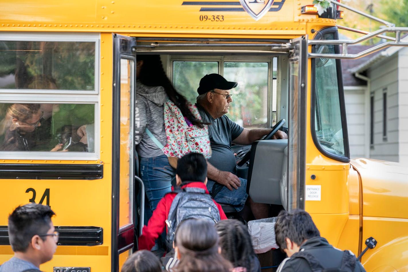 Don Brink picks up students on his route in Worthington, Minn. The town has seen an influx of undocumented children, but Brink does not support a plan to expand local schools.