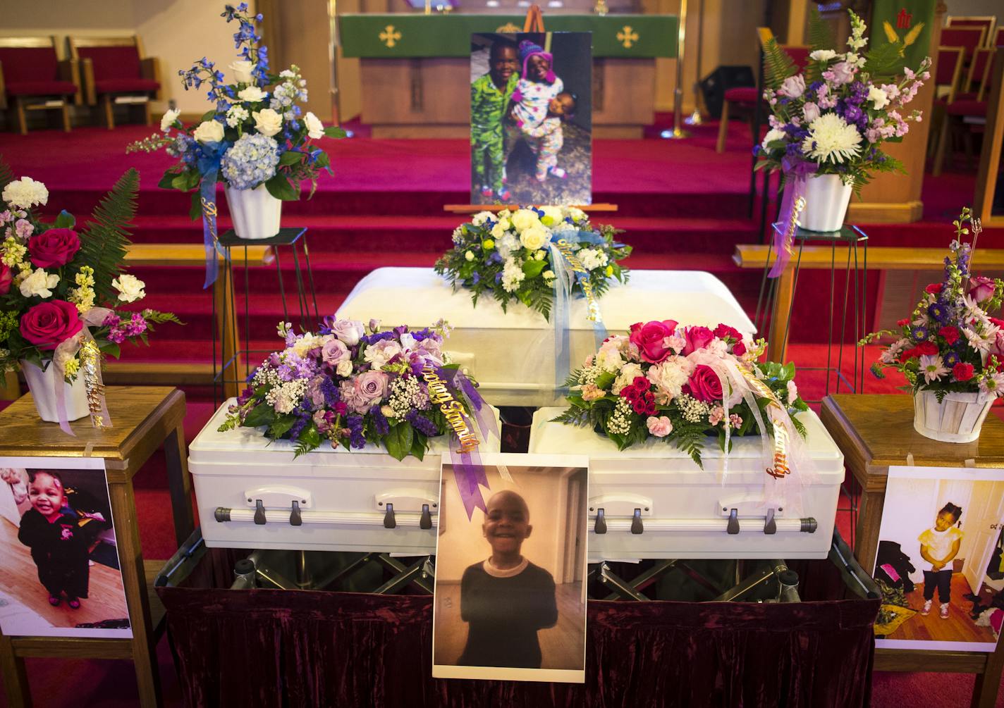 The caskets of siblings Latorious Thomas, 6, and his sisters Latoria, 5, and Latorianna, 23 months, were displayed during their funeral Saturday at Elim Lutheran Church in Robbinsdale. ] (AARON LAVINSKY/STAR TRIBUNE) aaron.lavinsky@startribune.com The funeral for siblings Latorious Thomas, 6, and his sisters Latoria, 5, and Latorianna, 23 months, was held Saturday, Oct. 17, 2015 at Elim Lutheran Church in Robbinsdale. The three children died in a north Minneapolis house fire on Oct. 4.