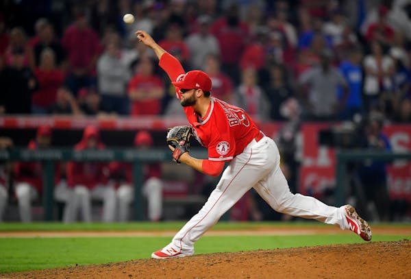 Los Angeles Angels relief pitcher Cam Bedrosian throws to the plate during the ninth inning of a baseball game against the Los Angeles Dodgers, Wednes