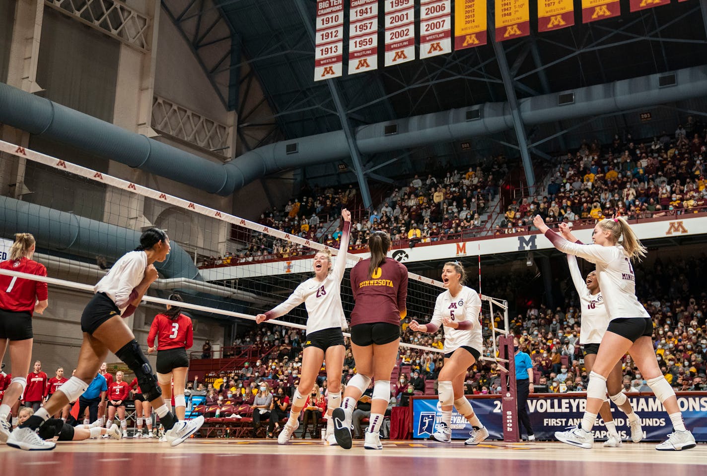 The University of Minnesota volleyball team celebrates after winning a point in the first set against the University of South Dakota in the first round of the NCAA tournament Friday, Dec. 3, 2021 in Maturi Pavilion in Minneapolis, Minn. ]