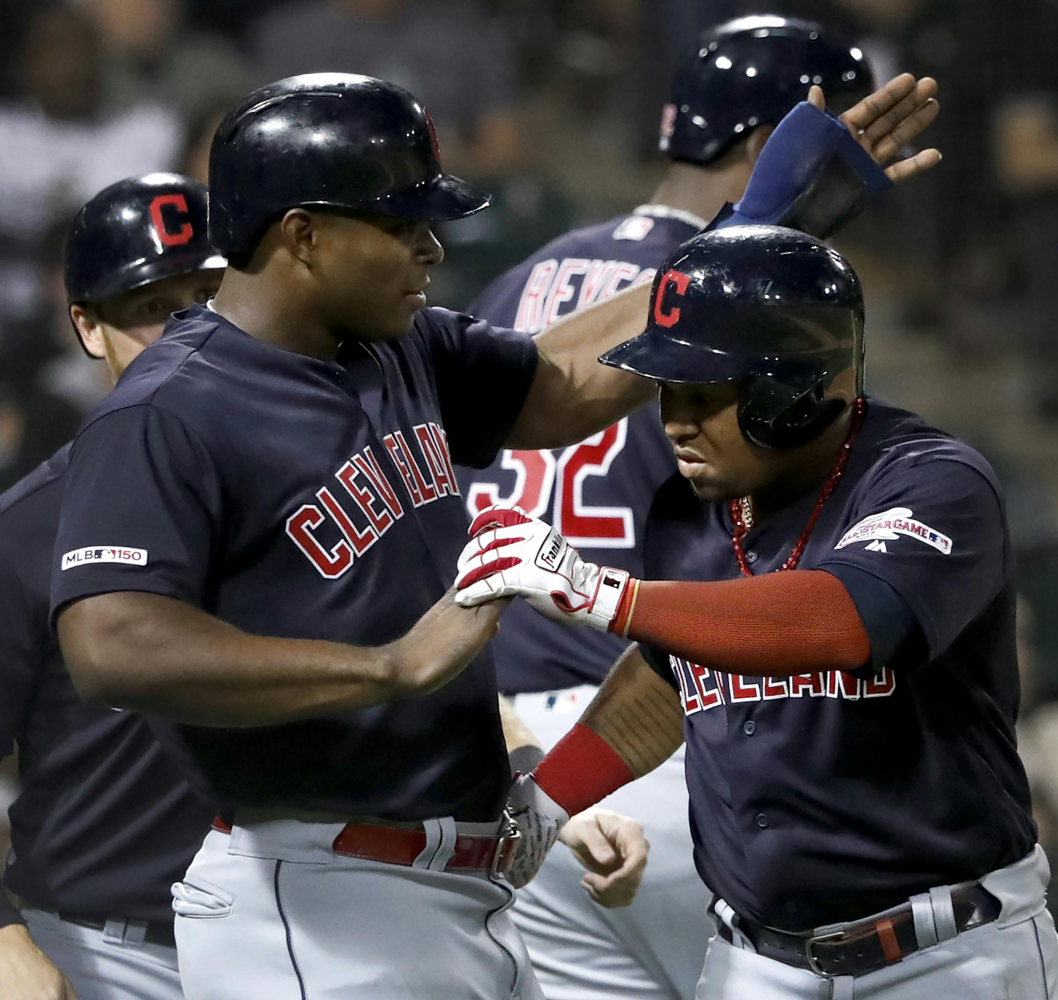 Cleveland Indians' Jose Ramirez, right, celebrates with Yasiel Puig, after Ramirez's three-run home run off Chicago White Sox's Hector Santiago during the third inning of a baseball game Tuesday, Sept. 24, 2019, in Chicago. (AP Photo/Charles Rex Arbogast)
