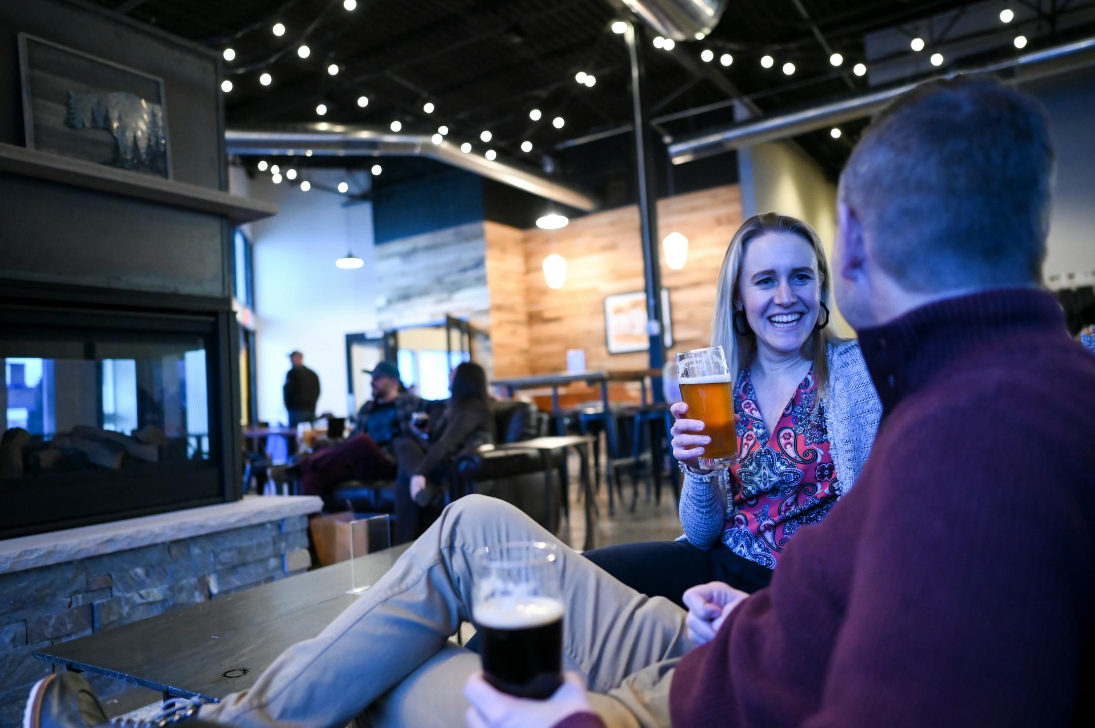 Mollie Bousu and her husband, Caleb, try each others' beers Wednesday, Feb. 9, 2022, at Nine Mile Brewing in Bloomington, Minn.