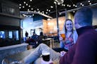 Mollie Bousu and her husband, Caleb, try each others' beers Wednesday, Feb. 9, 2022, at Nine Mile Brewing in Bloomington, Minn.