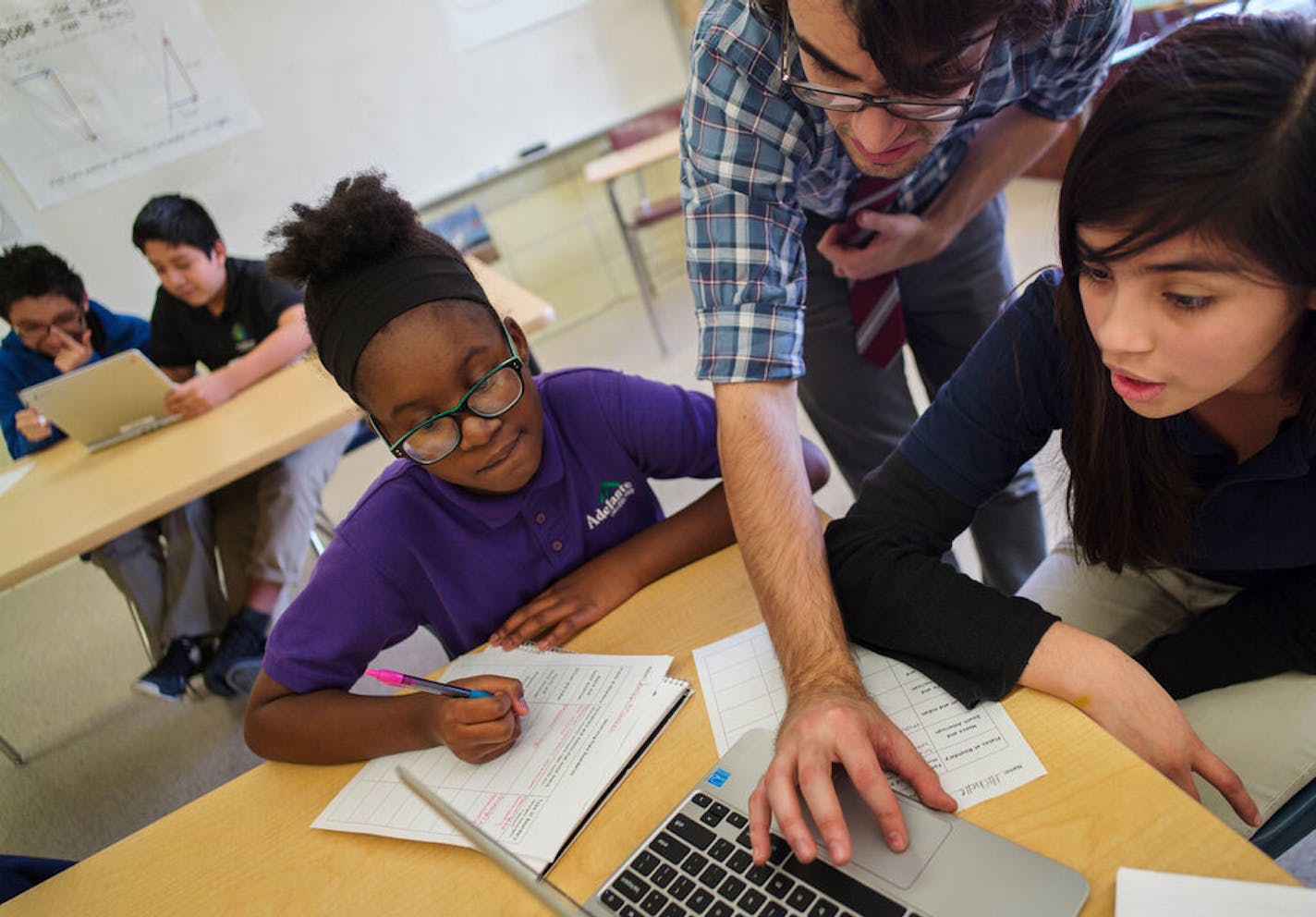 Science teacher Andres Gonzalez helped out students Jordan Mitchell, left, and Michelle Chavarria, right. Hiawatha Academies is fighting some history as it seeks approval for a plan to temporarily school its high school students at the old Northrop school for three years.Richard Tsong-Taatarii/ rtsong- taatarii@startribune.com