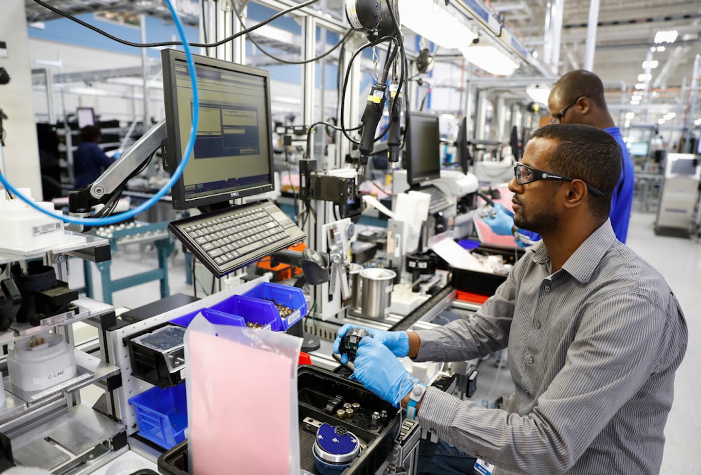 Employee Kalid Shafi assembled a wireless transmitter on the manufacturing floor of Emerson Automation Solution in Shakopee in September.