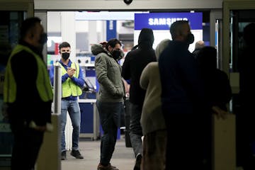 Black Friday shoppers file into Best Buy for the electronics retailer's early 5 a.m. opening Friday in Richfield.