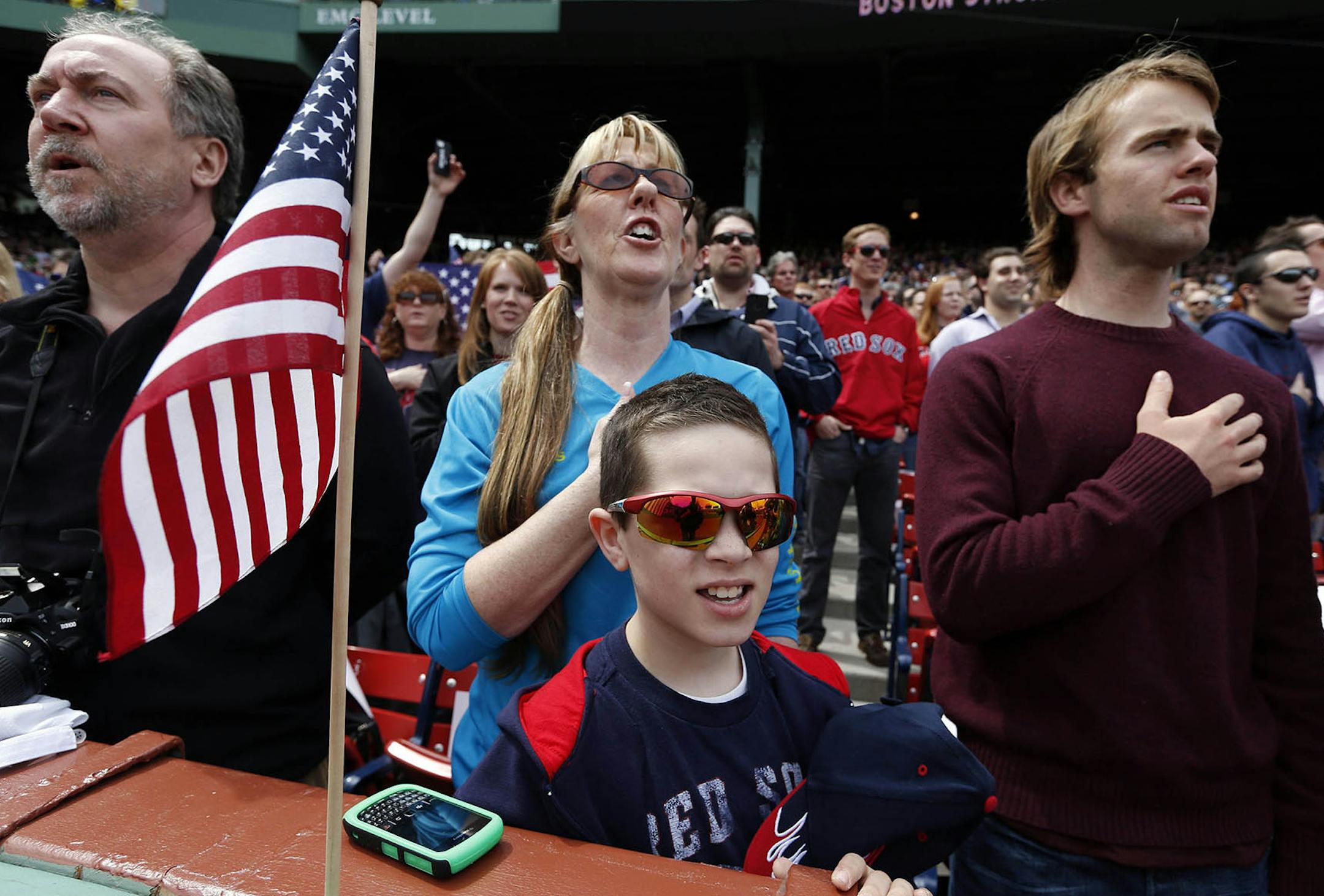 Fans, accompanied by the stadium organist, sang the anthem before a game between the Red Sox and Royals in Boston on Saturday.