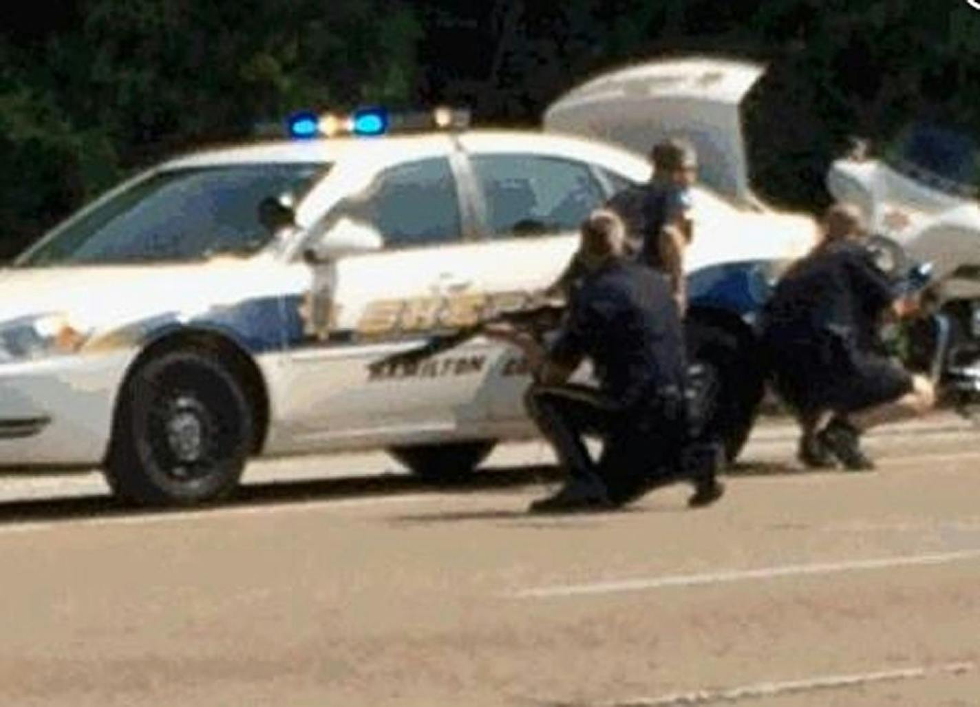 In this image made from video and released by WRCB-TV, authorities work an active shooting scene on Amincola Highway near the Naval Reserve Center, in Chattanooga, Tenn. on Thursday, July 16, 2015. Chattanooga Mayor Andy Berke says police are pursuing an active shooter after reports of a shooting at the military reserve center. (WRCB-TV via AP) MANDATORY CREDIT