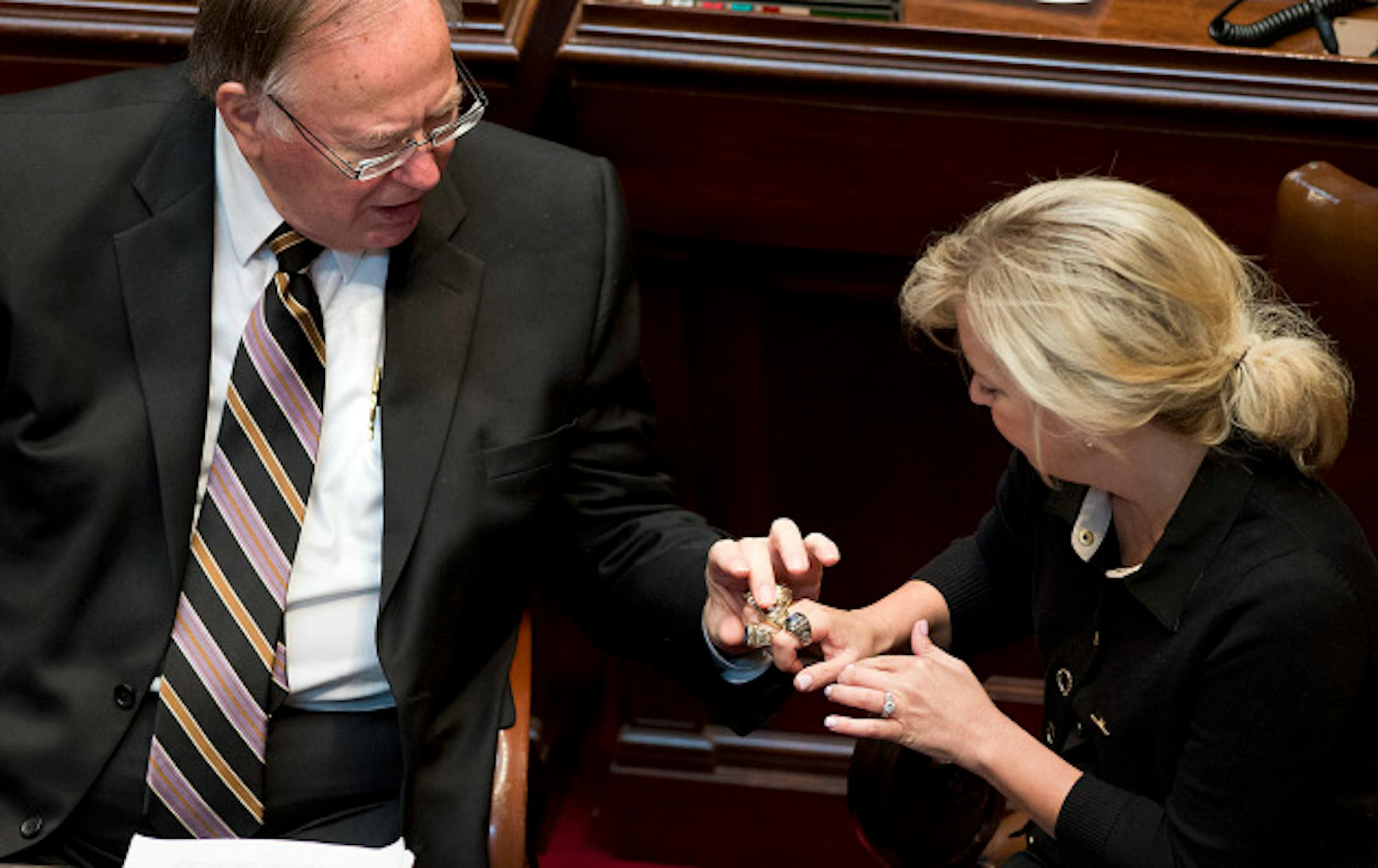 Sen. Karin Housley, right, showed past Minnesota Legislature rings to Sen. David Senjem.  Senators can order these rings from Josten's today,  Monday, May 20, 2013  ]   GLEN STUBBE * gstubbe@startribune.com