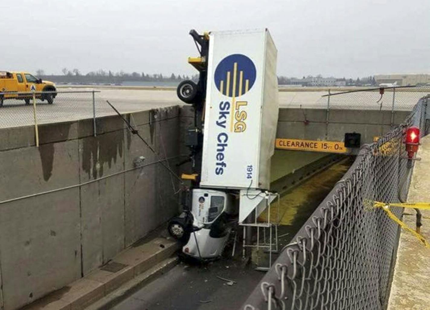 Two people were injured when an airport catering truck went headfirst over a barricade on its way to deliver food to an airplane at Minneapolis-St. Paul International Airport on Sunday morning. No one knows why the truck upended, but it took more than five hours to move the truck into a horizontal position again. The driver and passenger walked out of the van but were taken to the hospital with injuries that weren't life-threatening.