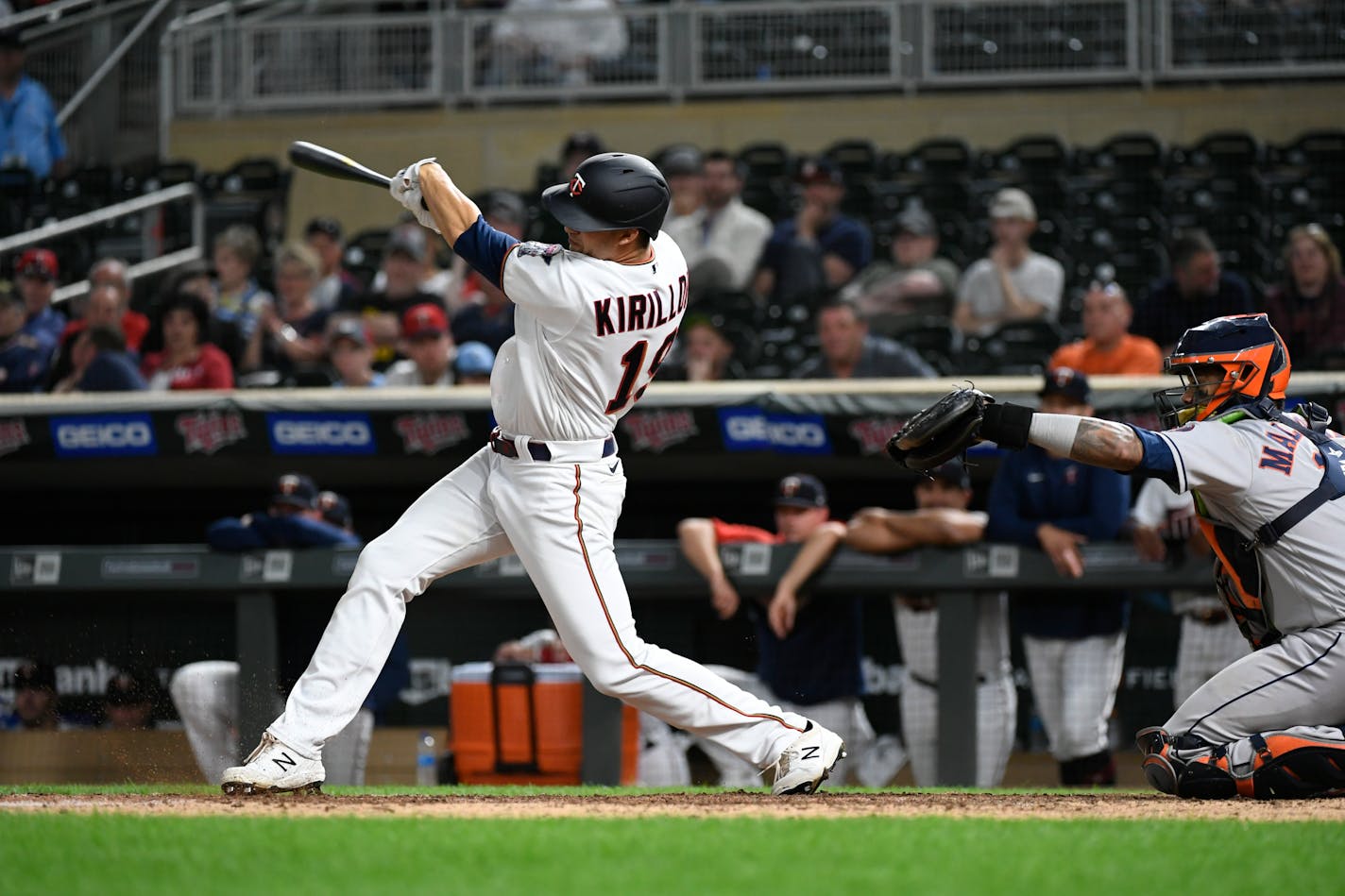 Minnesota Twins' Alex Kirilloff hits a base hit in front of Houston Astros catcher Martin Maldonado during the ninth inning of a baseball game, Tuesday, May 10, 2022, in Minneapolis. The Astros won 5-0. (AP Photo/Craig Lassig)