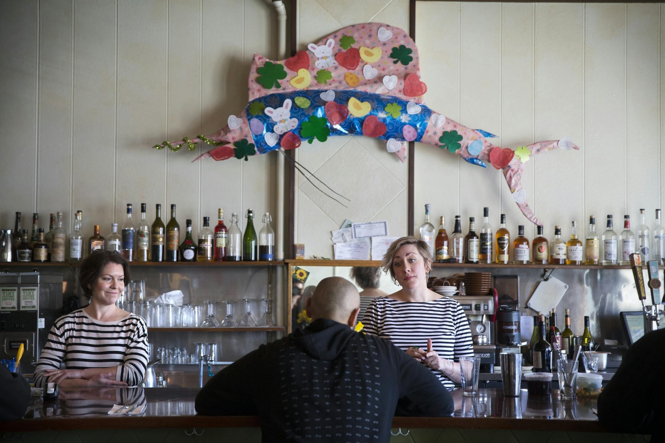 Servers/bartenders Raleigh Phillips, left, who has worked for Modern Cafe for over ten years, and Erikka Curran, who has worked there six years, tend bar at the Modern Cafe in Minneapolis on Tuesday, March 10, 2015.