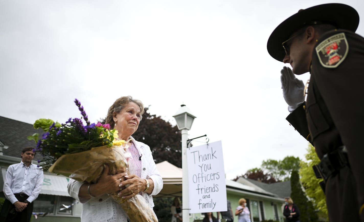 A representative from the Washington County Sheriffs Department and the Law Enforcement Memorial Association (LEMA) handed Jeanette Sackett, widow of slain St. Paul Police Officer James Sackett, a bouquet of flowers outside her home Friday on the 50th anniversary of her husband's death in the line of duty. ] aaron.lavinsky@startribune.com Jeanette Sackett can't go one day without thinking about what she's lost. It's been 50 years since her police officer husband, James Sackett, was slain in an a