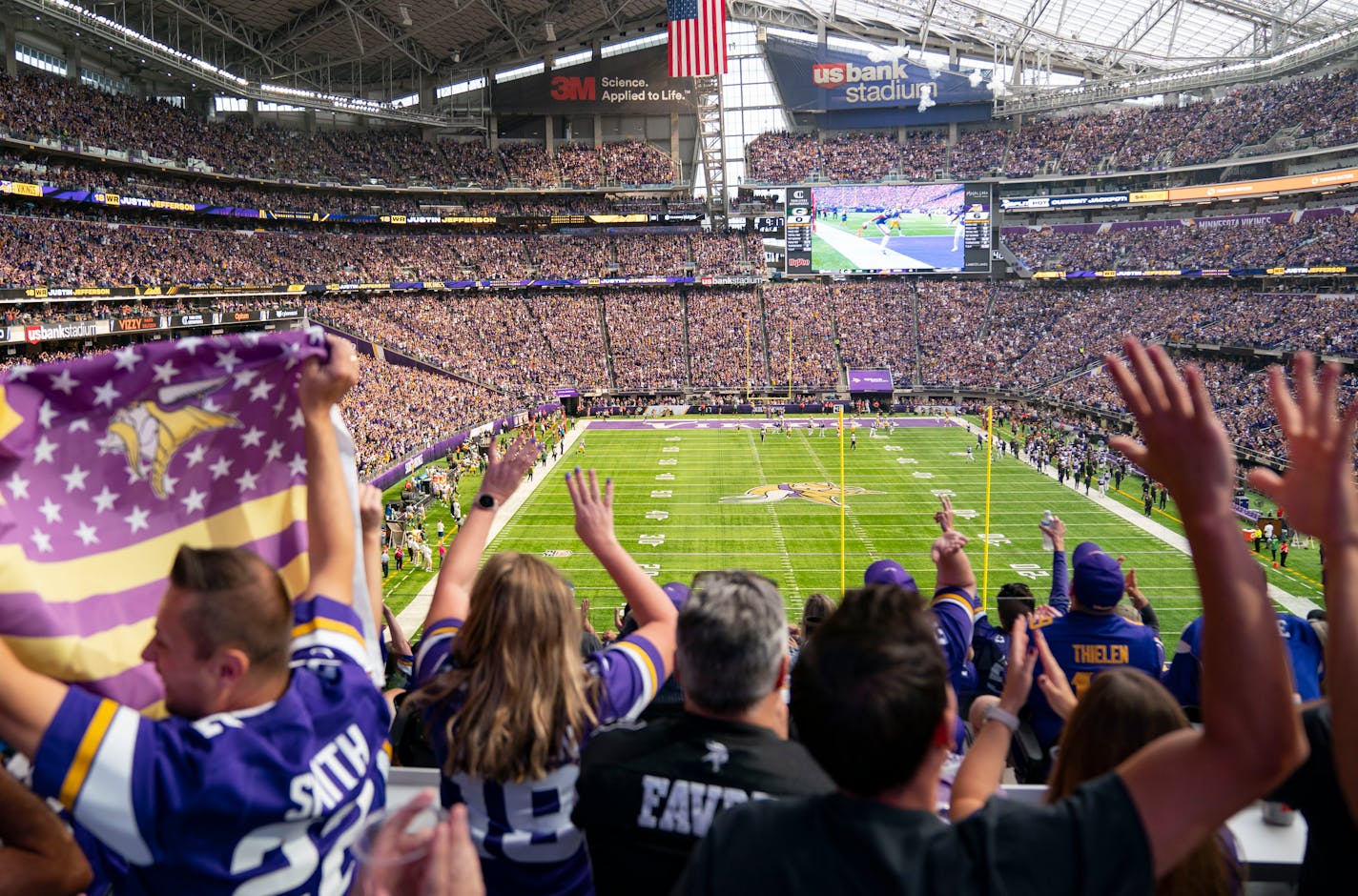 Minnesota Vikings fans celebrate after Minnesota Vikings wide receiver Justin Jefferson (18) scores a touchdown in the first quarter.