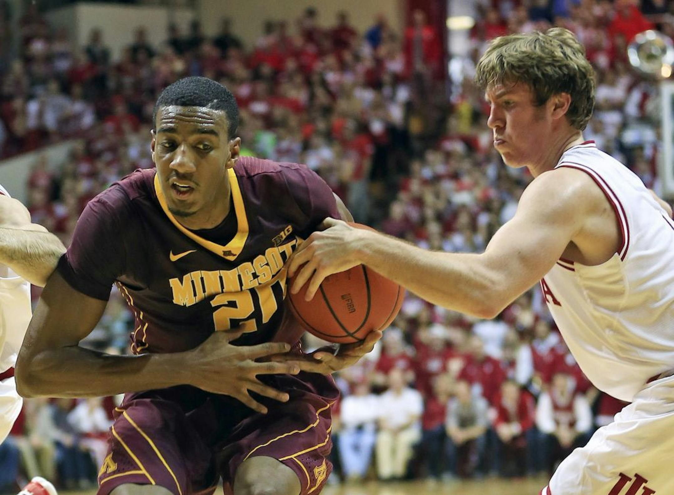 Indiana's Jordan Hulls (1) knocks the the ball away from Minnesota's Austin Hollins (20) earlier this season.