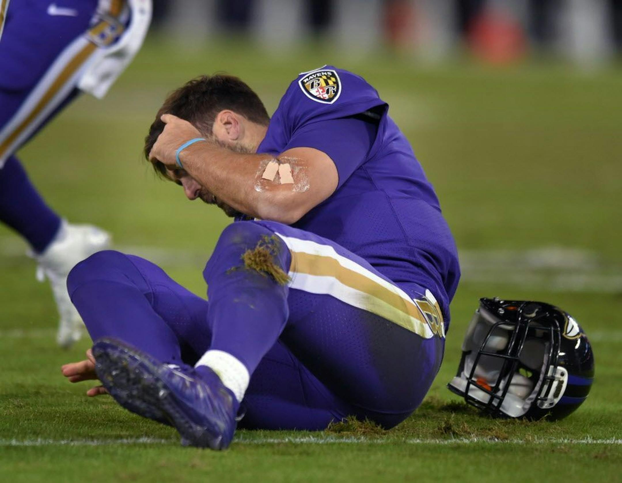 Baltimore Ravens quarterback Joe Flacco is slow to get up after being hit by the Miami Dolphins' Kiko Alonso in the second quarter at M&T Bank Stadium in Baltimore on Thursday, Oct. 26, 2017. The Ravens won, 40-0.