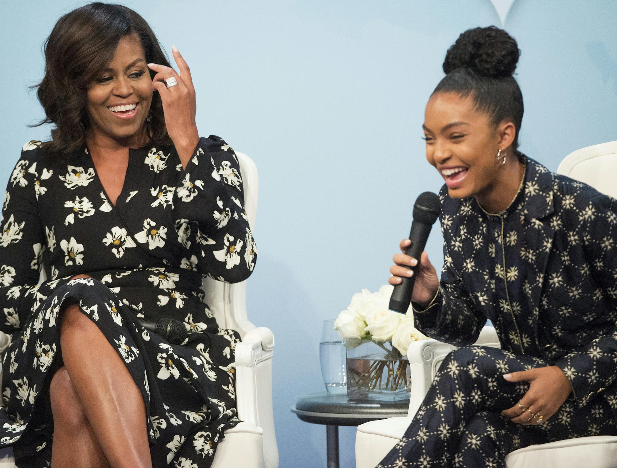 FILE - In this Oct. 11, 2016, file photo, first lady Michelle Obama laughs with actress Yara Shahidi while participating in Glamour's "A Brighter Future: A Global Conversation on Girls' Education," in celebration of International Day of the Girl and Let Girls Learn at the Newseum in Washington. Shahidi tells W magazine for an article published online on March 13, 2017, that Obama wrote her a college recommendation letter. (AP Photo/Molly Riley, File)