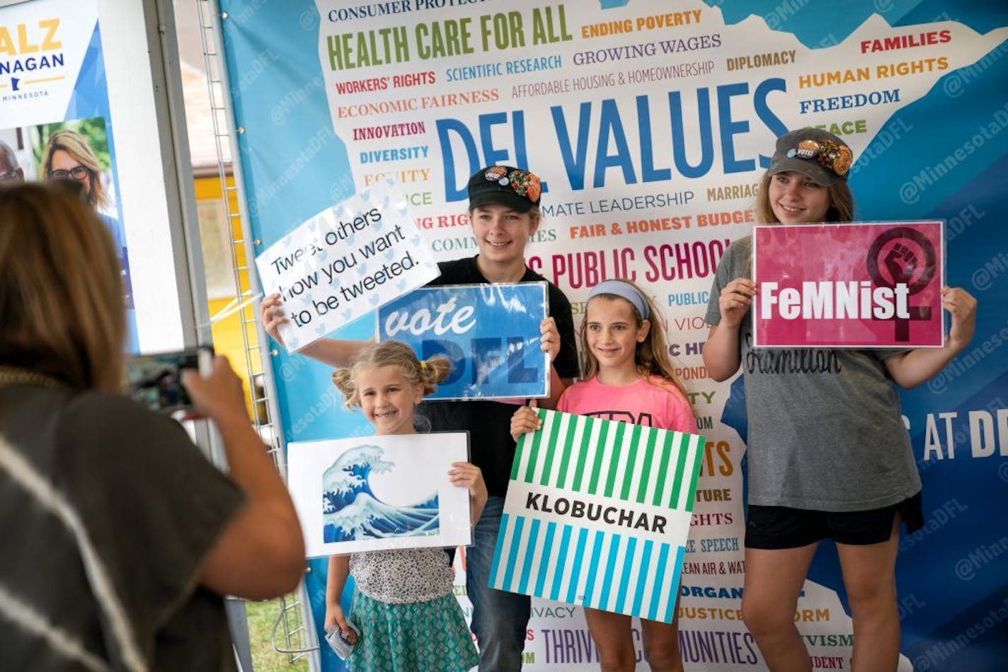 Alanna and Lizzie Halloran, both 13, and Avi Fettig, 6, and Delia Fettig, 9 wanted their photos taken at the DFL booth at the Minnesota State Fair.