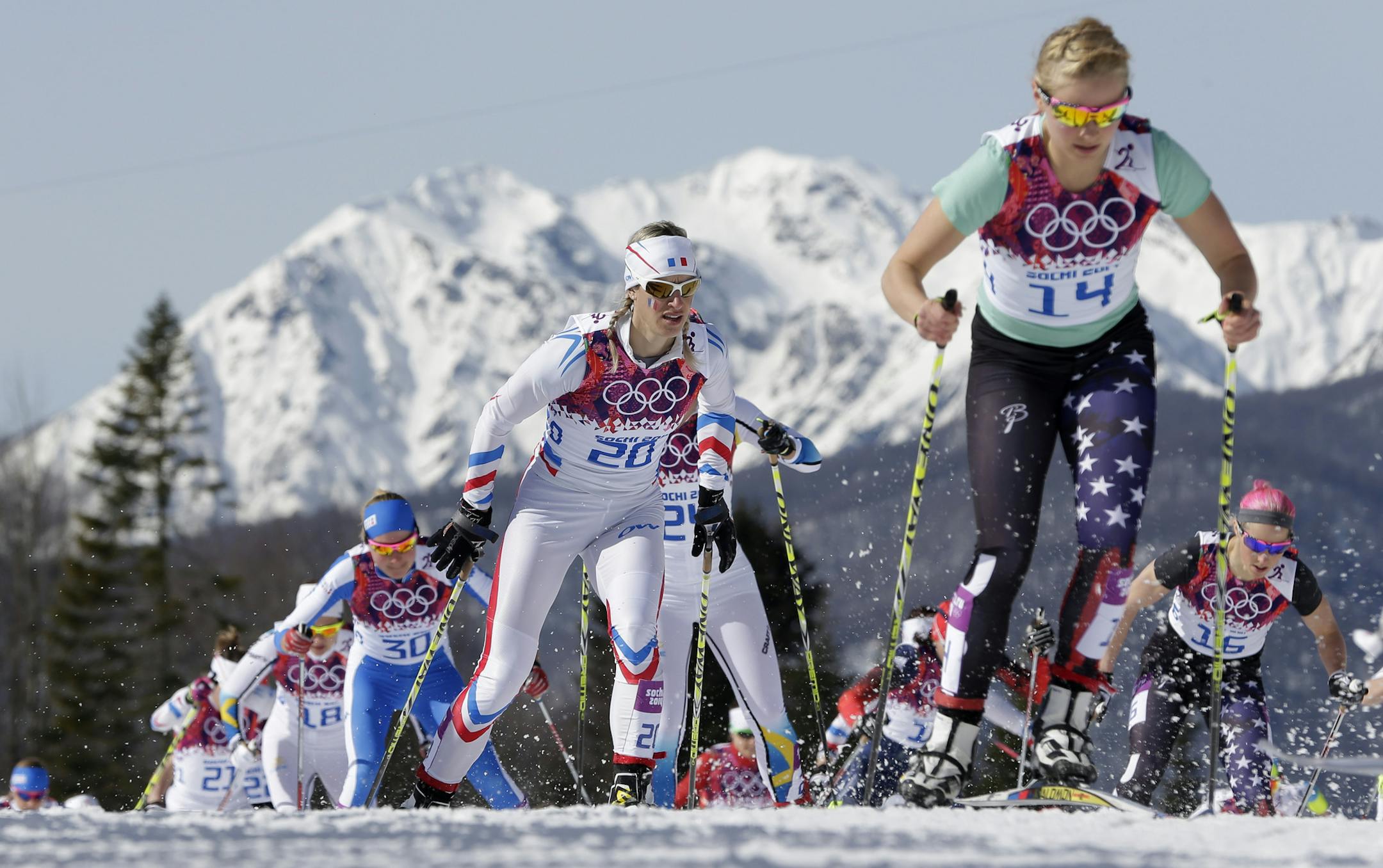 United States' Jessica Diggins, right, and France's Aurore Jean, center, compete during the women's 30K cross-country race at the 2014 Winter Olympics, Saturday, Feb. 22, 2014, in Krasnaya Polyana, Russia. (AP Photo/Matthias Schrader)
