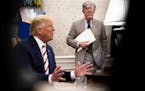 FILE -- John Bolton, then the national security adviser, watches as President Donald Trump hosts the Romanian president in the Oval Office, at the Whi